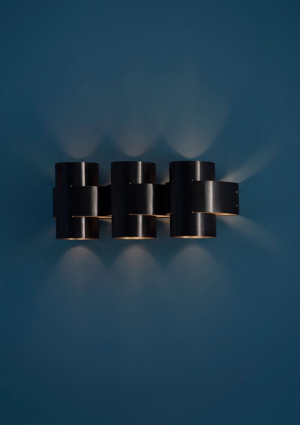 PLUS Series is a new range of appliqués by Paul Matter that feature a simple shape in singular and repetitive arrangements. A 3-Dimensional plus is formed out of a single tube of brass that is cut, bent and finished. The light source nestled within