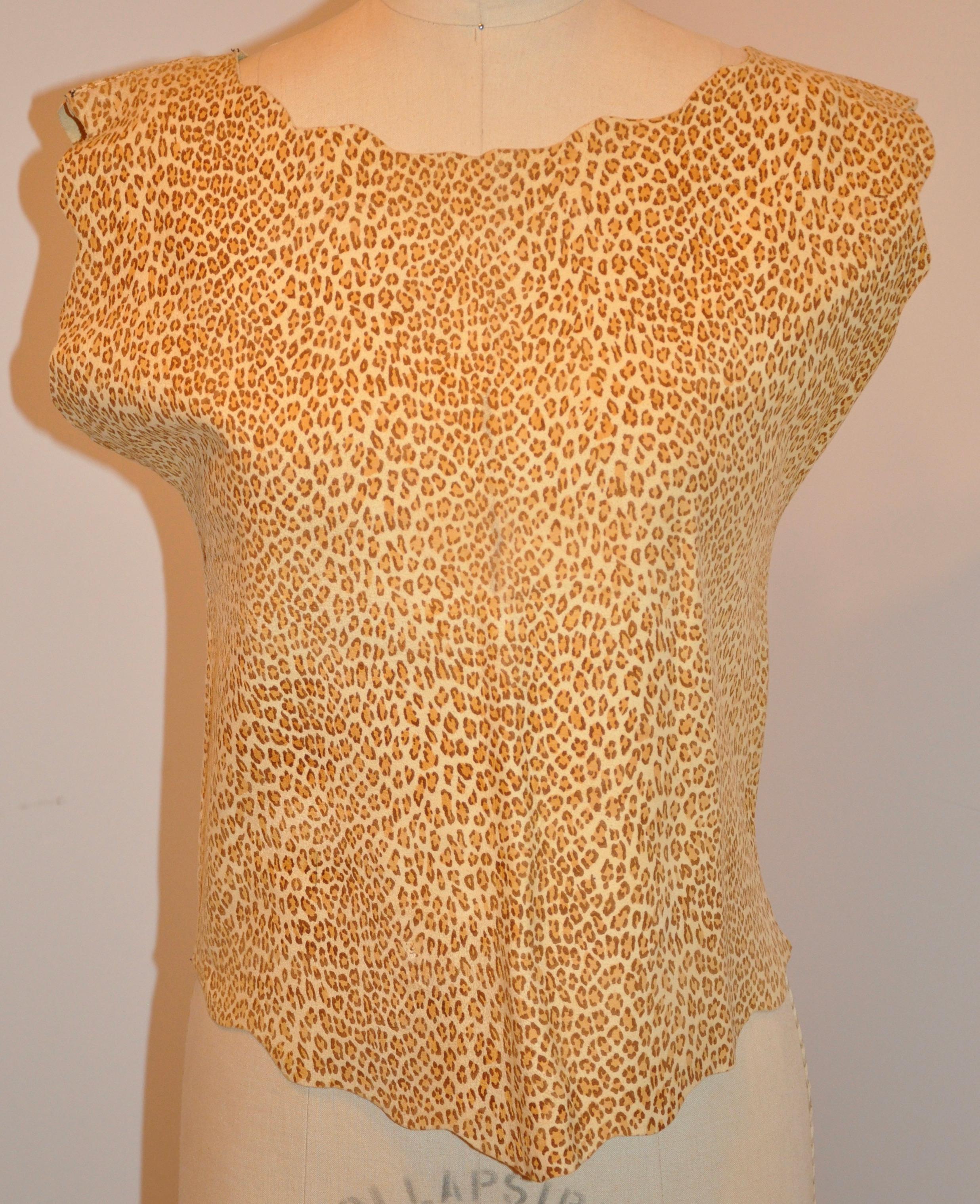     This wonderfully soft plush chamois leather leopard-print finished with scallop edges pullover measures 22 inches in length. The shoulders across measures 16 1/2 inches, underarm circumference is 18 1/4 inches, waist is 34 inches, hem
