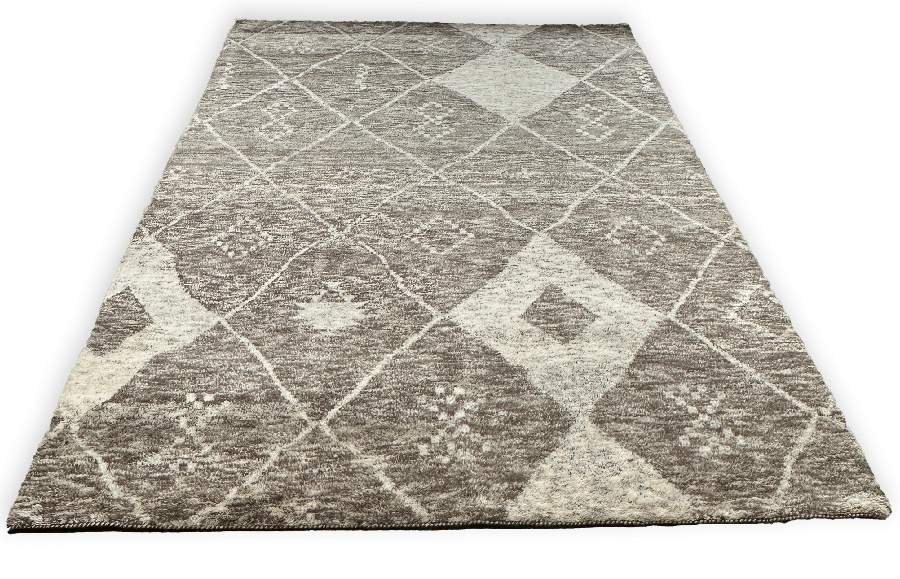 Elevate your home décor with the Plush Moroccan Rug, showcasing a mesmerizing concentric diamond pattern. This luxurious rug effortlessly blends traditional Moroccan artistry with contemporary design, featuring a harmonious palette of beige and