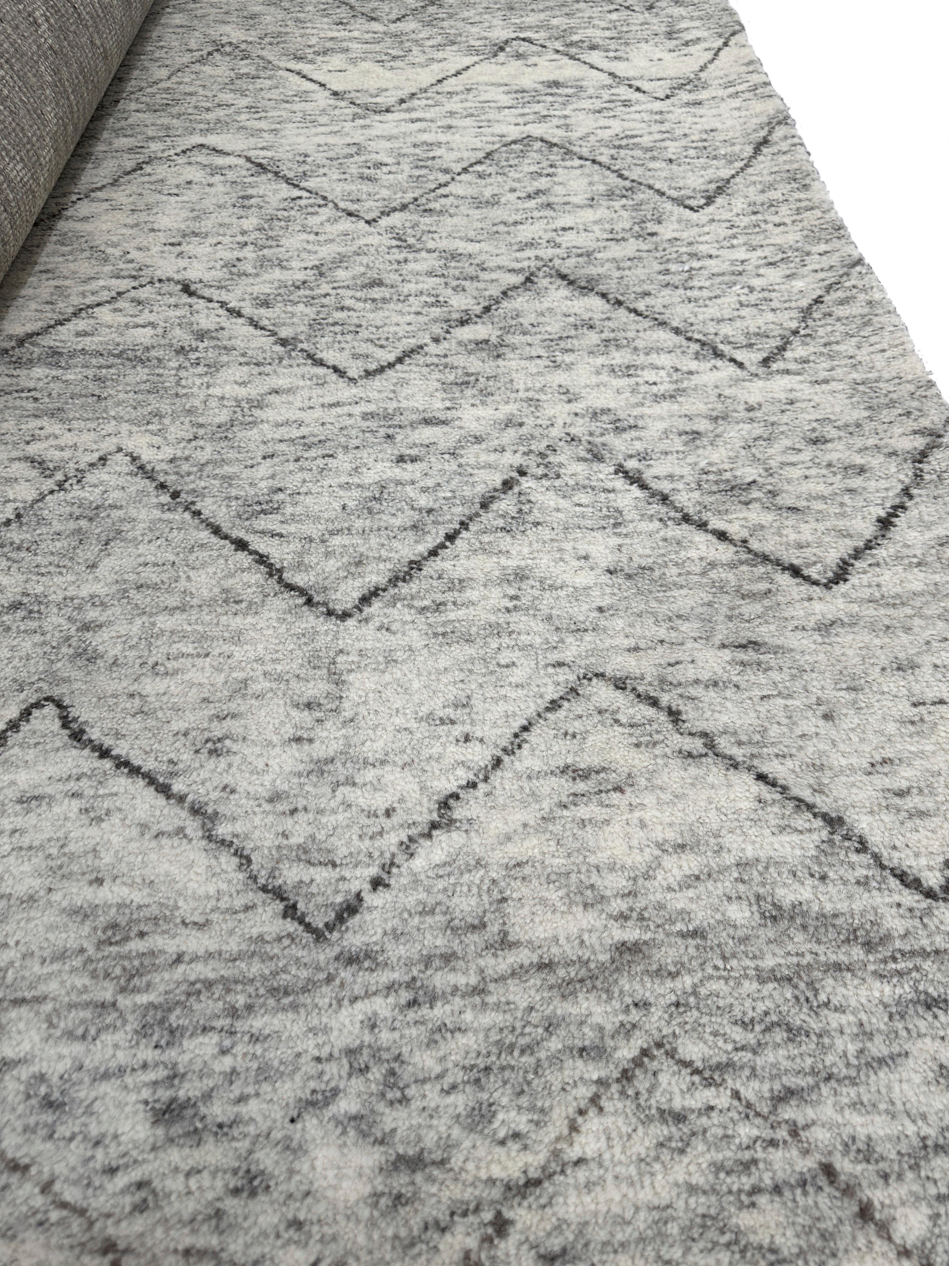 Transform your living space with the exquisite charm of our plush Moroccan chevron rug. Designed to bring a touch of sophistication and warmth to any room, this rug features a timeless chevron pattern in soothing shades of beige and brown. The