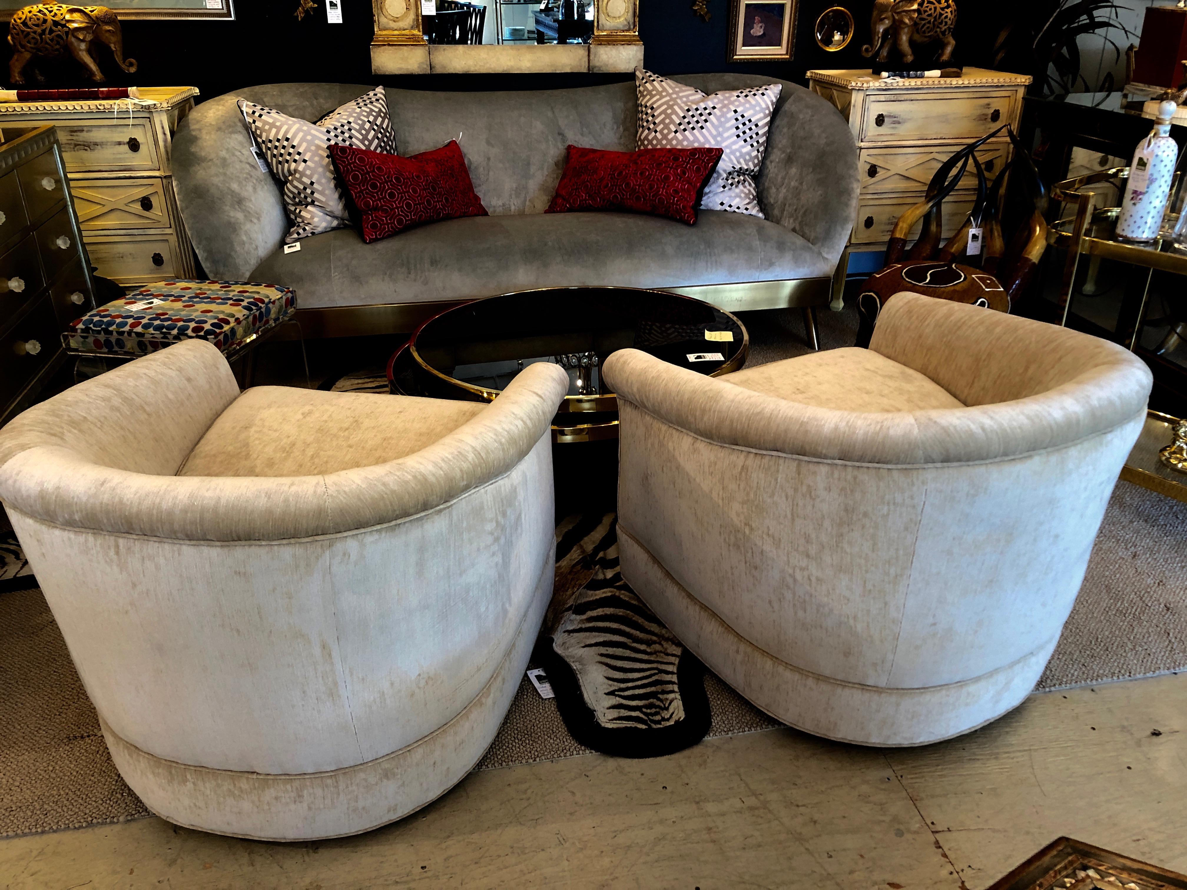 A Milo Baughman style pair of curvy club chairs that swivel, having brand new soft camel colored velvet upholstery. Super solid and comfy.
Measures: seat depth 23 inches.