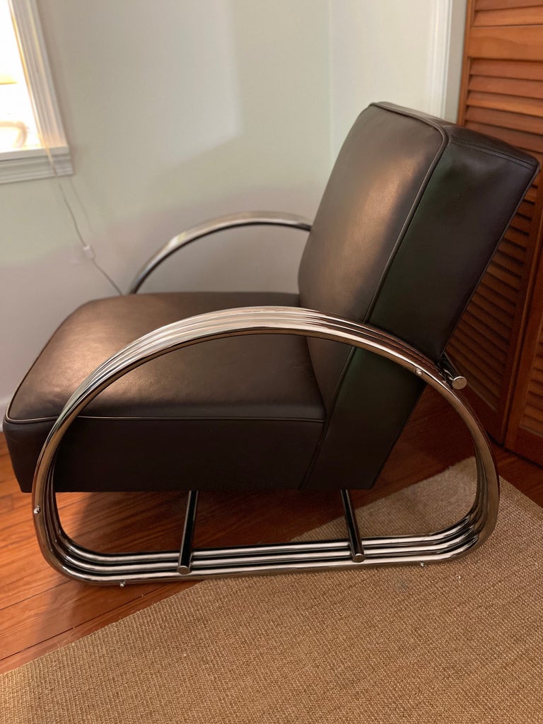 Rich chocolate brown leather and triple band mirrored chrome Hudson St. lounge chair has a sumptuous blend of comfort, modernism and sophistication.  Tight padded seat and back, and cool from every angle.  No label.

