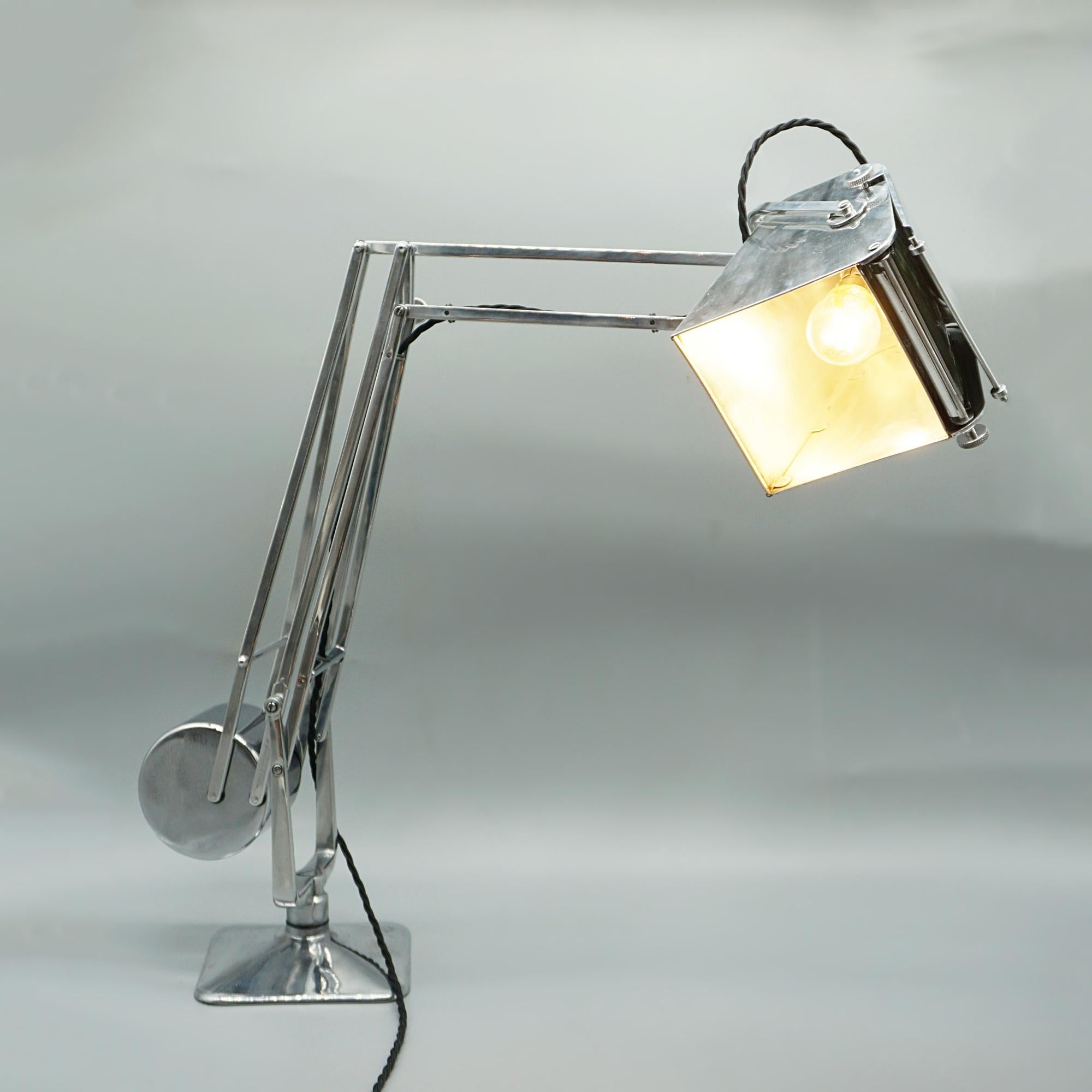 A long reach pluslite table lamp with magnifying glass by Hadrill & Horstmann. Originally designed and used for map reading. 

Dimensions: Max H 76cm Max Reach 90cm 

Origin: English

Date: Circa 1940

Item Number: J361

All of our lighting is fully