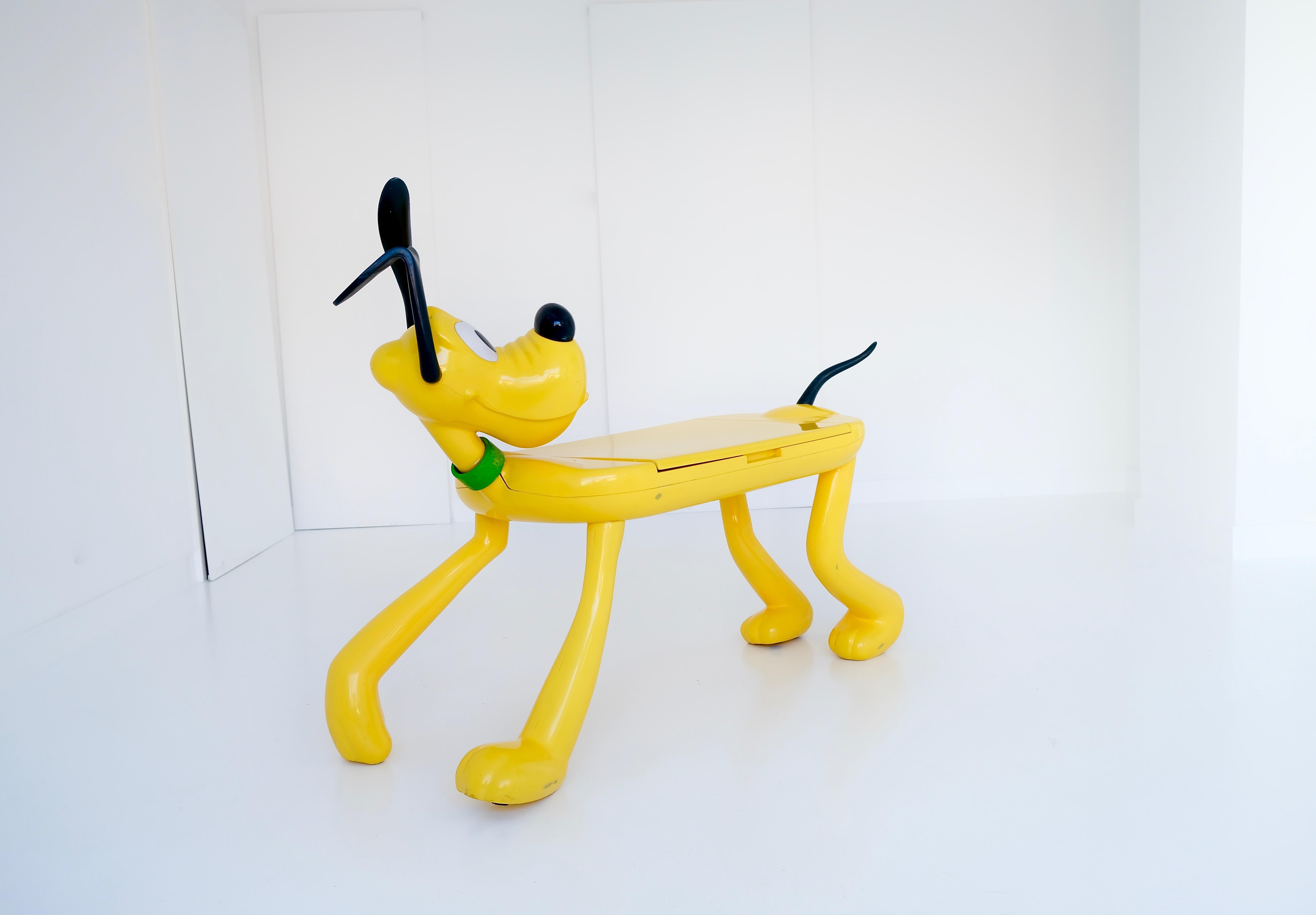 ‚Pluto‘ kids table / play desk, by Pierre Colleu for Disney, manufactured by Starform, France, 1980s, painted resin, laminated wood, plastic, rubber. Good original condition with minor wear, consistent with age and usage.

The ‚Pluto‘ table mimics