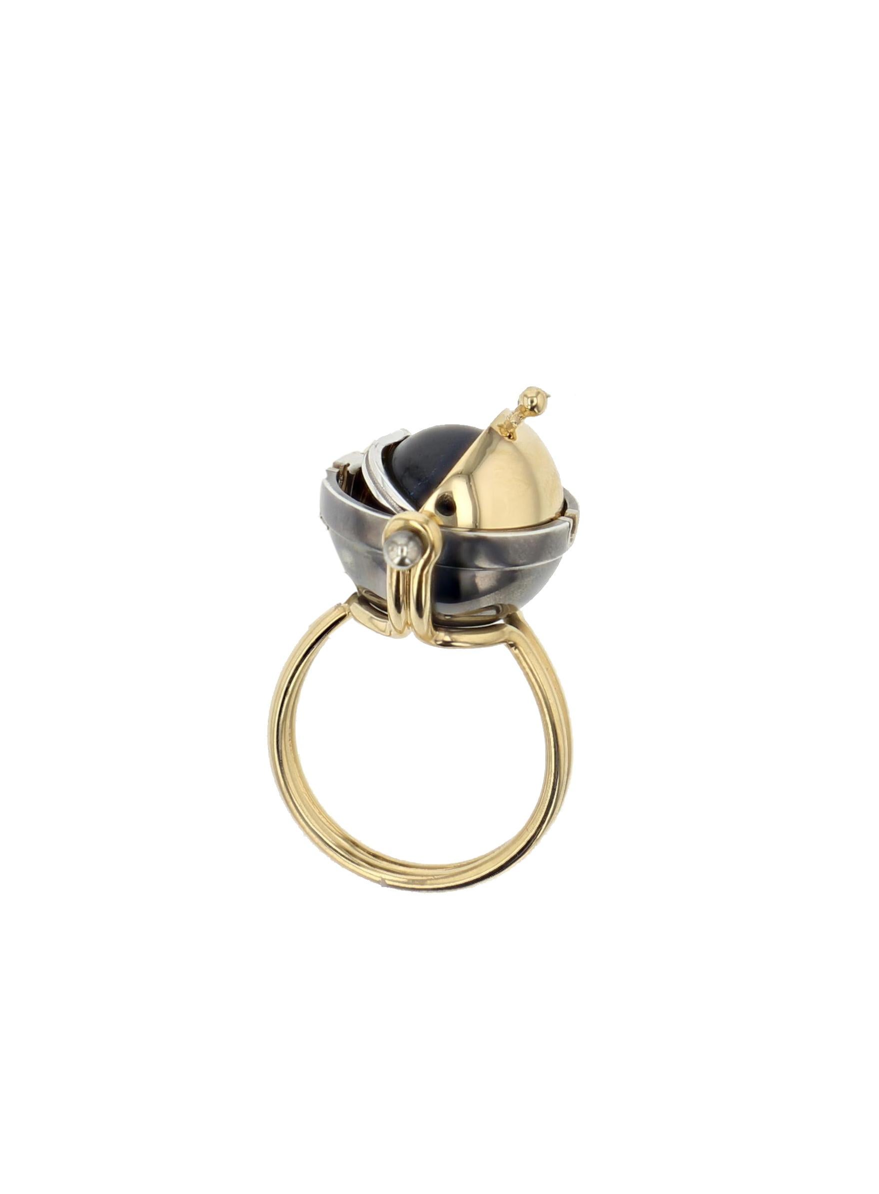 Labradorite Diamond Sphere Ring in 18k yellow gold by Elie Top. Pluton Sphere Ring made of a 18K Yellow Gold and patinated silver structure, mounted by a pivotating sphere that hides or reveals a labradorite circled by a diamond satellite. 
