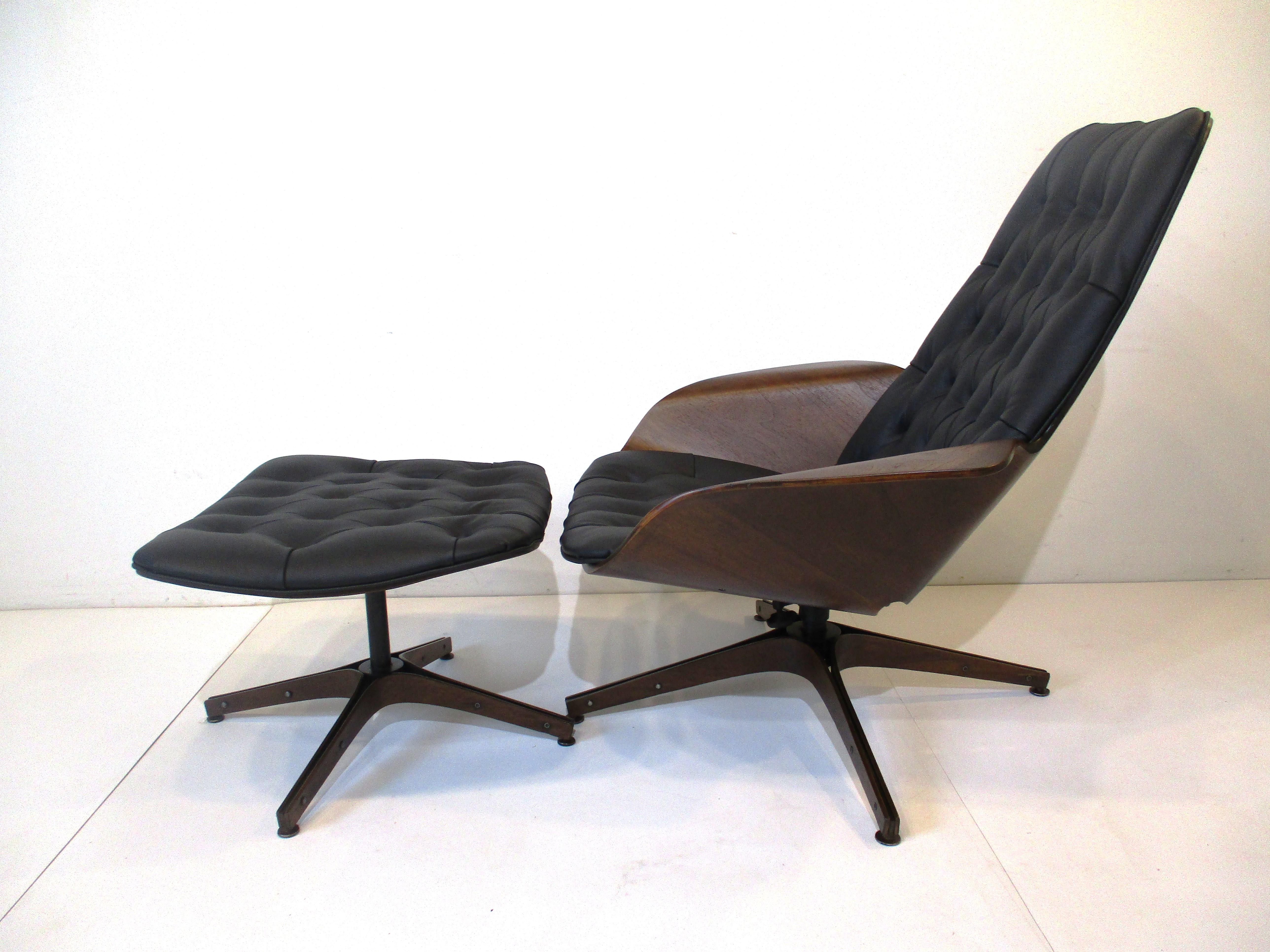 A sculptural dark walnut bent wood framed lounge chair with matching ottoman both with tuffed black soft leather cushions . The star bases have bent wood and steel legs with foot pads , both chair and ottoman swivel for comfort . The Mr. Chair