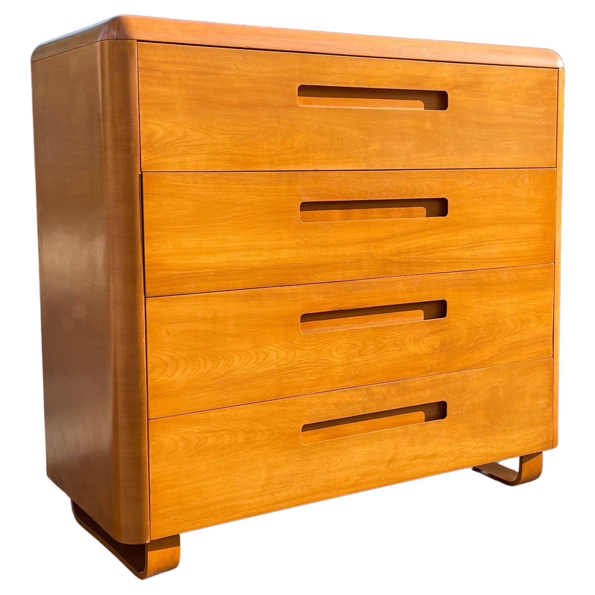 A beautiful midcentury four-drawer tall dresser with bentwood legs designed by Paul Goldman for his 