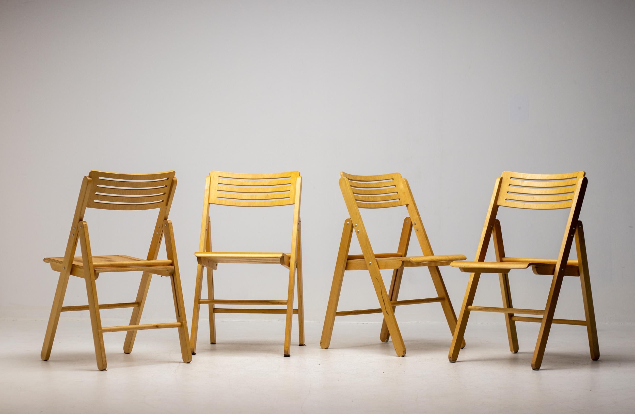 Foldable chairs in plywood, made in The Netherlands circa 1980.  Ingeniously designed practical and sturdy chairs in very good condition. These folding chairs offer a versatile seating solution with numerous benefits. Their collapsible design makes