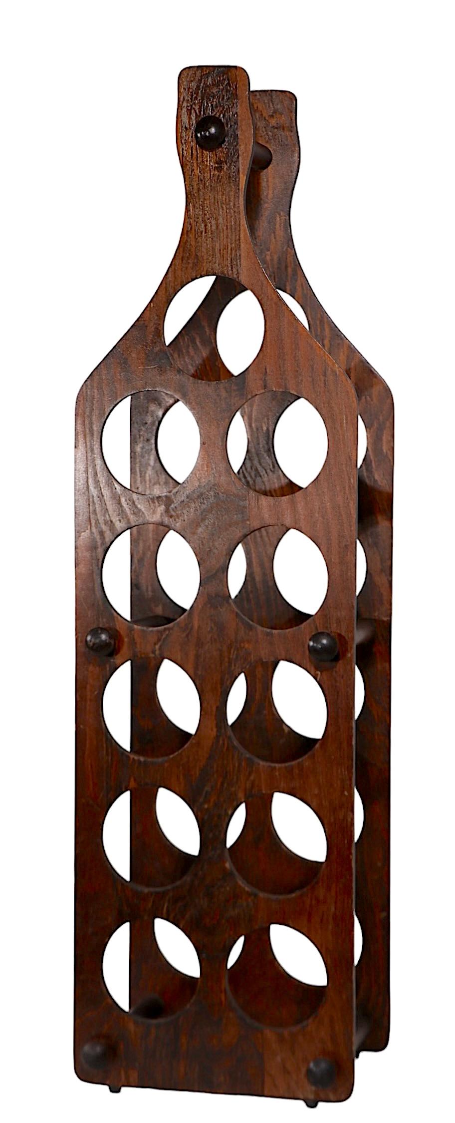 Groovy 1970's plywood wine rack  in  the form of a large wine bottle. The rack is constructed of two plywood boards, each with 11 holes, to accommodate the bottles, joined by 5 solid wood cross bars. This example is in very good, clean, original,