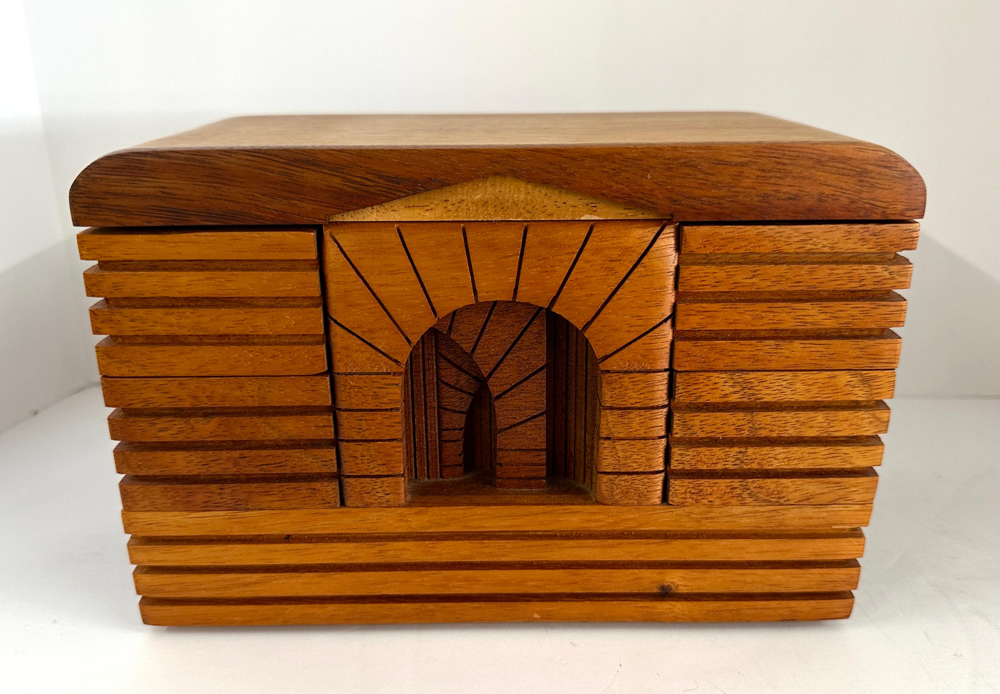 Wonderful architectural box by the talented British born California artist Po Shun Leong. Signed on the base and dated 87, it is made of Koa and Mahogany. In good vintage age appropriate condition with some minor flaws which are pictured in the