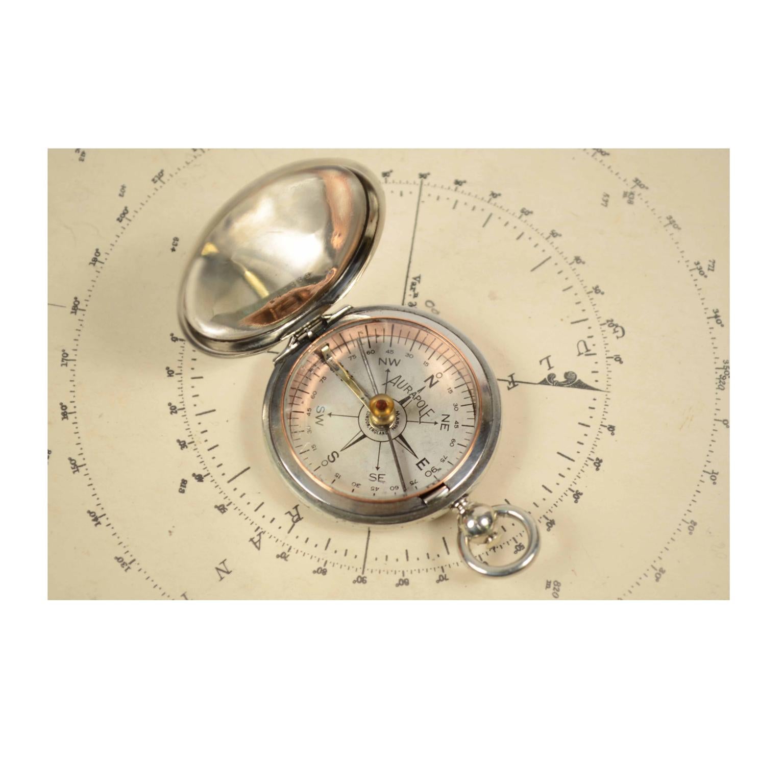 Pocket compass, 1915, of chromed brass in the shape of a pocket watch, signed Aurapole Short & Mason London, England. The compass has a snap-on cover with release button inside the ring. Compass card with eight winds complete with a goniometric