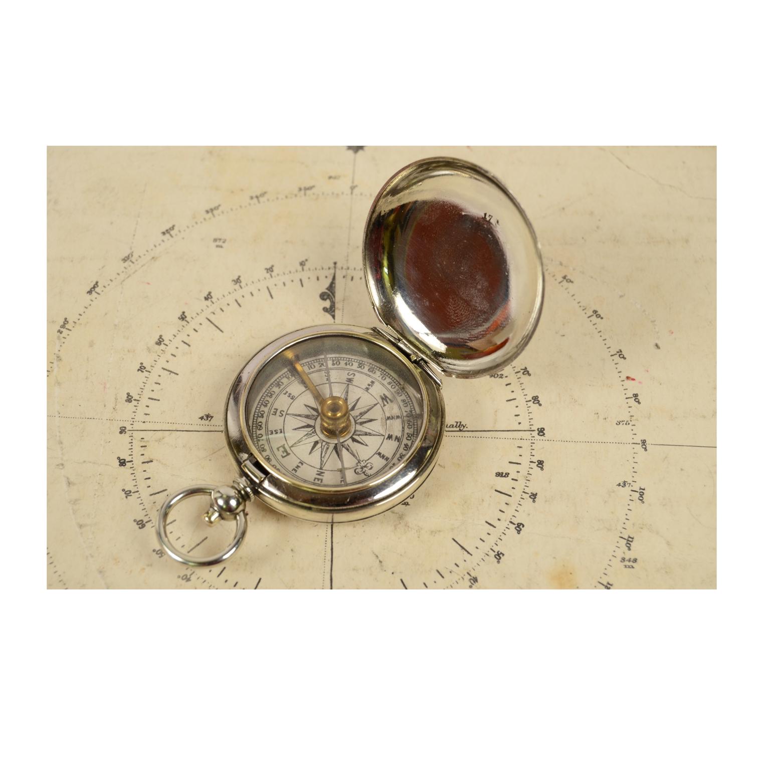 Officer pocket compass of chromed brass shaped like a pocket watch. Made in England in the early 1900s. The compass is equipped with a lid with snap closure with release button inside the ring. Compass card with sixteen winds complete with