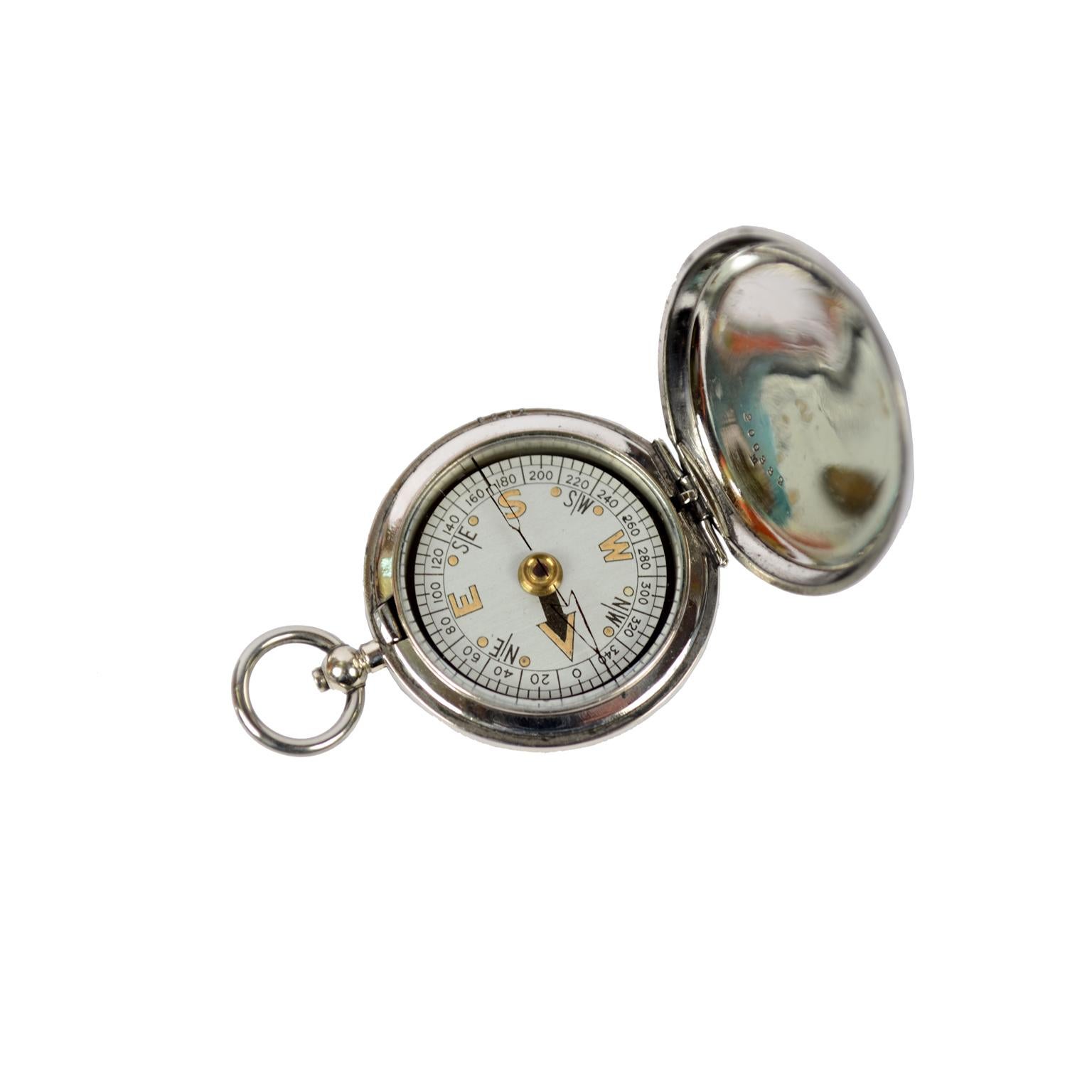 Pocket compass used by RAF officers, 1926, of chromed brass in the shape of a pocket watch, signed Short & Mason VI A130. The compass has a snap-on cover with release button inside the ring. Compass card with four winds complete with a goniometric