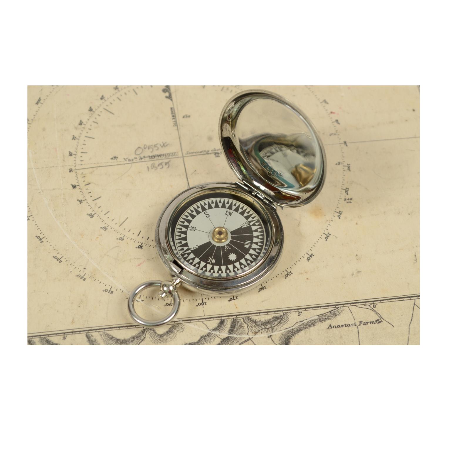 Pocket compass used by the Royal Air Force officers in 1916 circa made of chromed brass in the shape of pocket watch, signed Short & Mason Ltd London V 83417. The compass is equipped with a lid with a snap closure with release button inside ring.