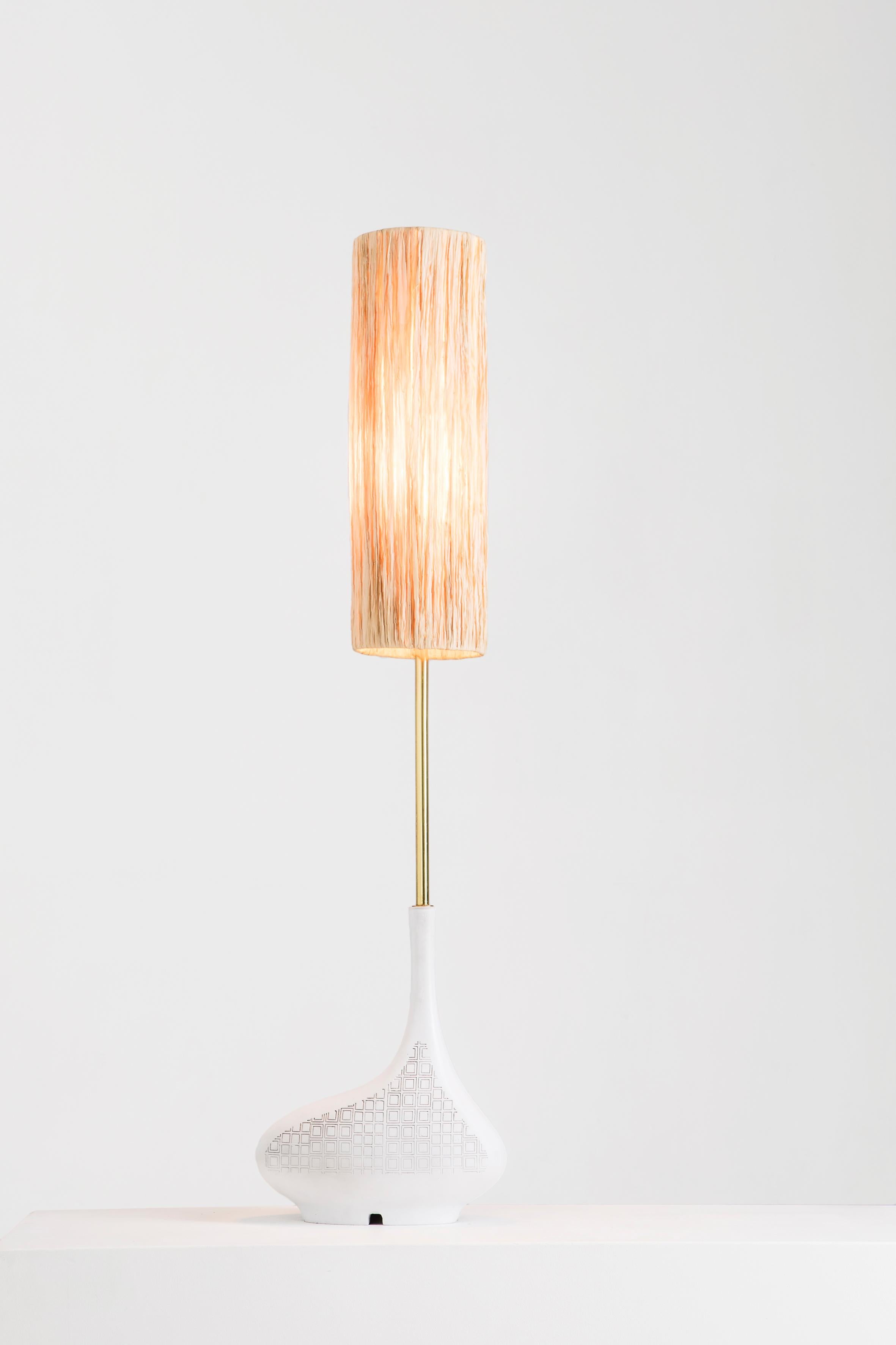 Pod single table lamp by Egg Designs
Dimensions: 30 L X 30 D X 58 H cm
Materials: composite casting, brass, raffia.

Founded by South Africans and life partners, Greg and Roche Dry - Egg is a unique perspective in contemporary furniture inspired