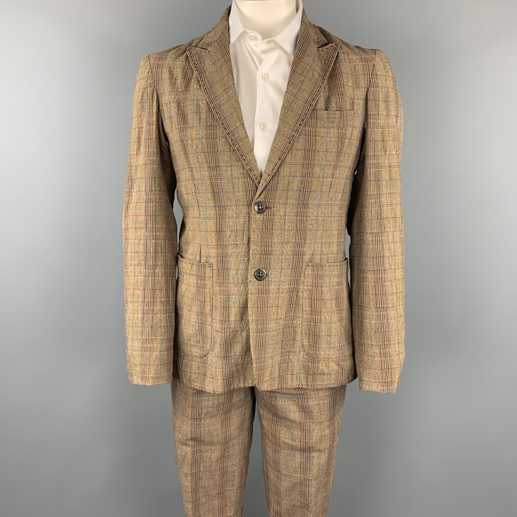 PODOLL suit comes in a brown plaid cotton blend and includes a single breasted, two button sport coat with a peak lapel and matching flat front trousers.

Good Pre-Owned Condition.
Marked: M

Measurements:

-Jacket
Shoulder: 18.5 in.
Chest: 38