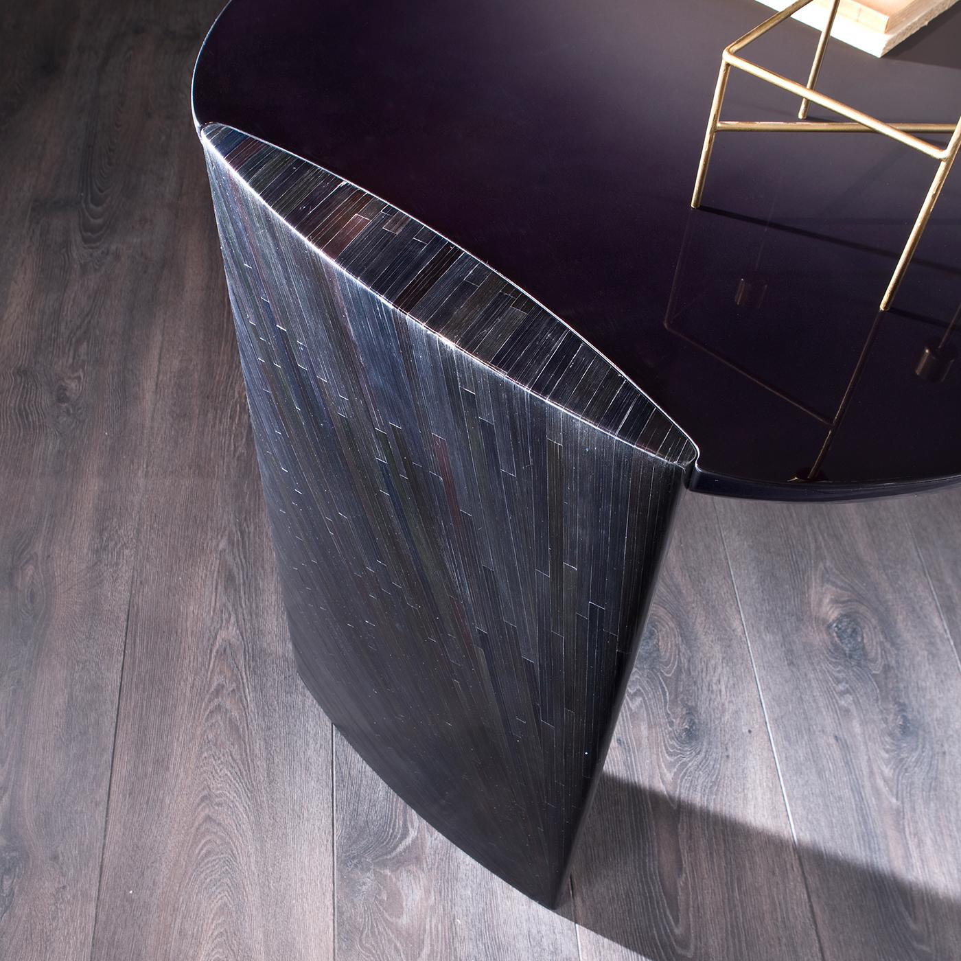 Minimal and luxurious, this round desk is the ideal decor for a modern home. Fashioned of wood with a glossy shaded lacquer, the silhouette's delicate curves of the irregular top boast a glossy shaded lacquer that strikingly contrasts with the