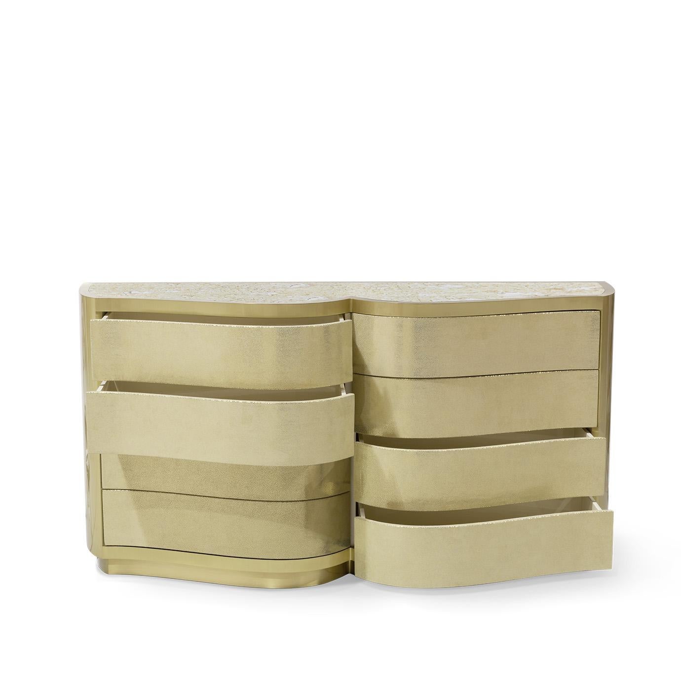 The delicate undulating front of the Poem Chest and its leather upholstered body framed by metal bands exudes modern vintage glamour. The top of this stunning chest is finished with a sheet of aged mirror.