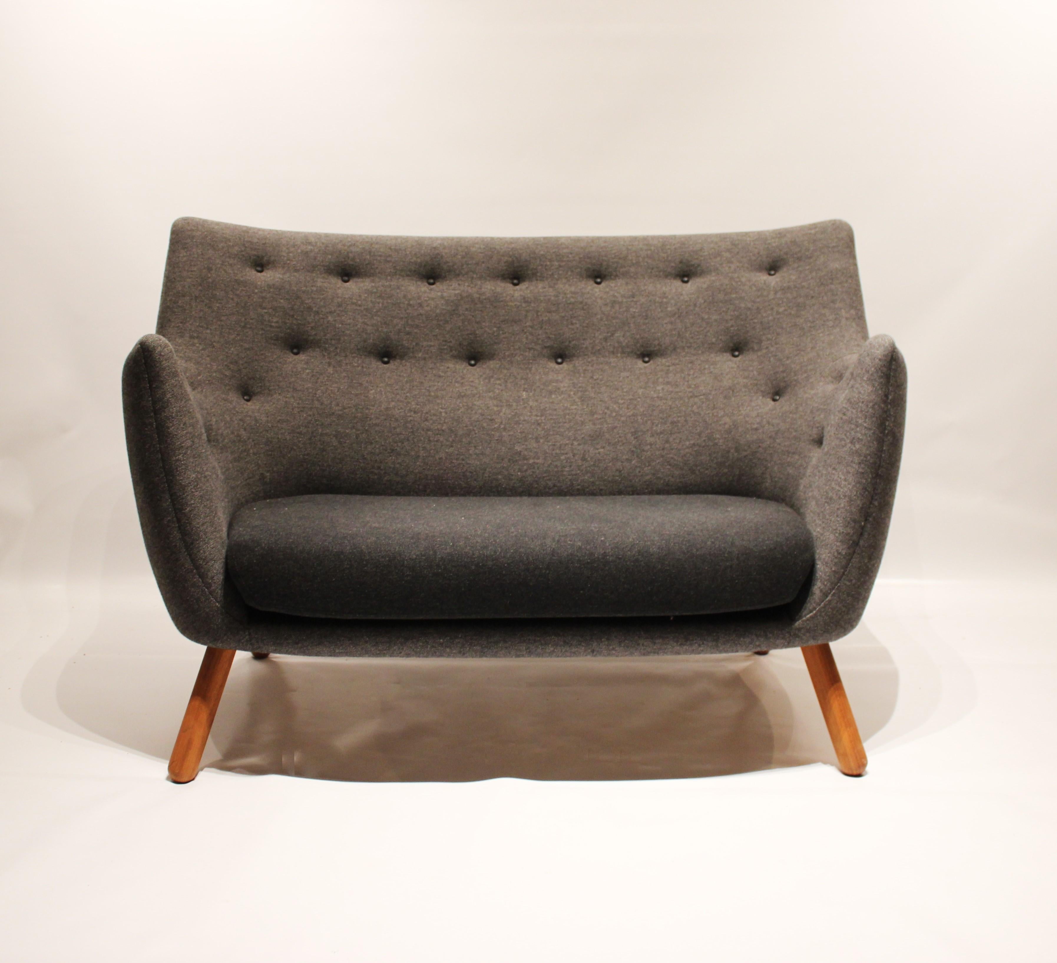 Poet rime sofa, model FJ4100, designed by Finn Juhl in 1941 and manufactured by Onecollection. The chair is upholstered with dark grey Hallingdal and legs of walnut.