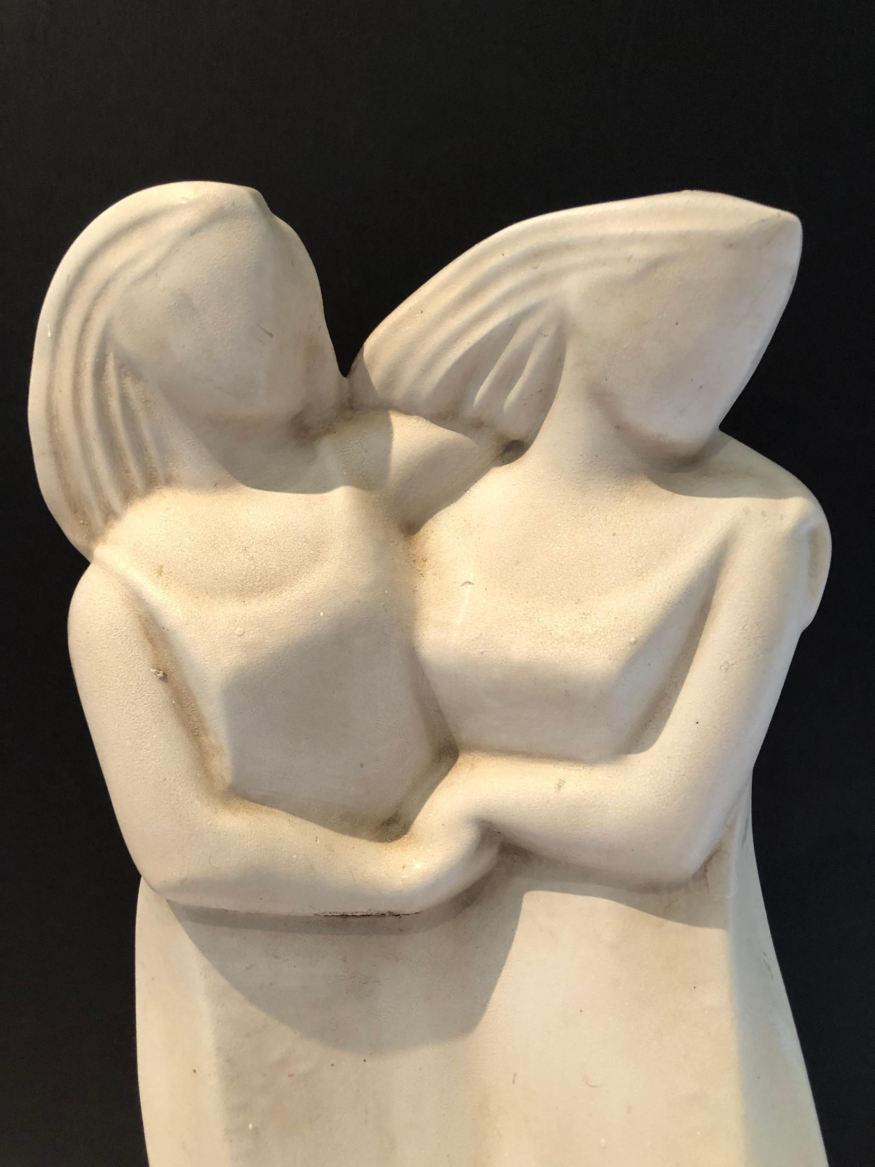 A gorgeous vintage abstract Art Deco style plaster sculpture of two women lovingly holding hands and in an affectionate position, one arm sweetly around the other's shoulders and waist. The art is beautiful from every angle and striking in its