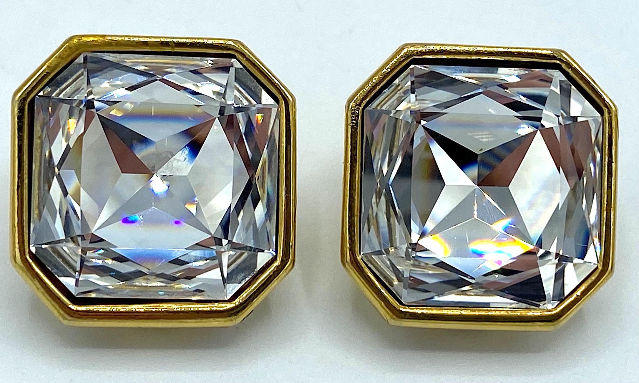 An elegant pair of large 1 inch square faceted crystal rhinestone button earrings by French fashion jewelry company Poggi. Each stone is set into an 18K gold plate mounting with a clip back. The back of each earring has an oval plaque inscribed