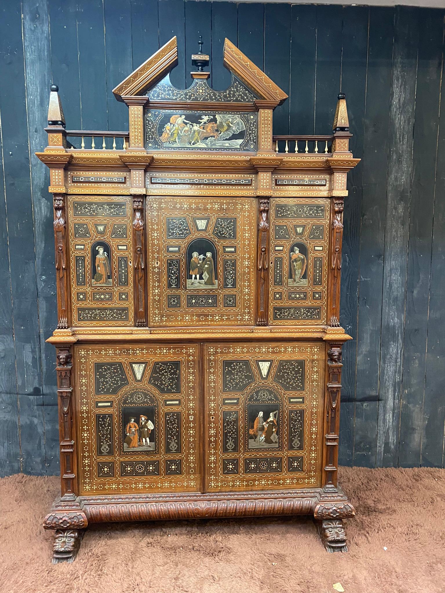 Walnut cabinet inlaid and inlaid with ebony, copper, mother-of-pearl, bone and brass opening with 3 doors in the upper part and two doors in the lower part. Amount decorated with caryatids, front legs in the shape of lion heads. Neo Renaissance