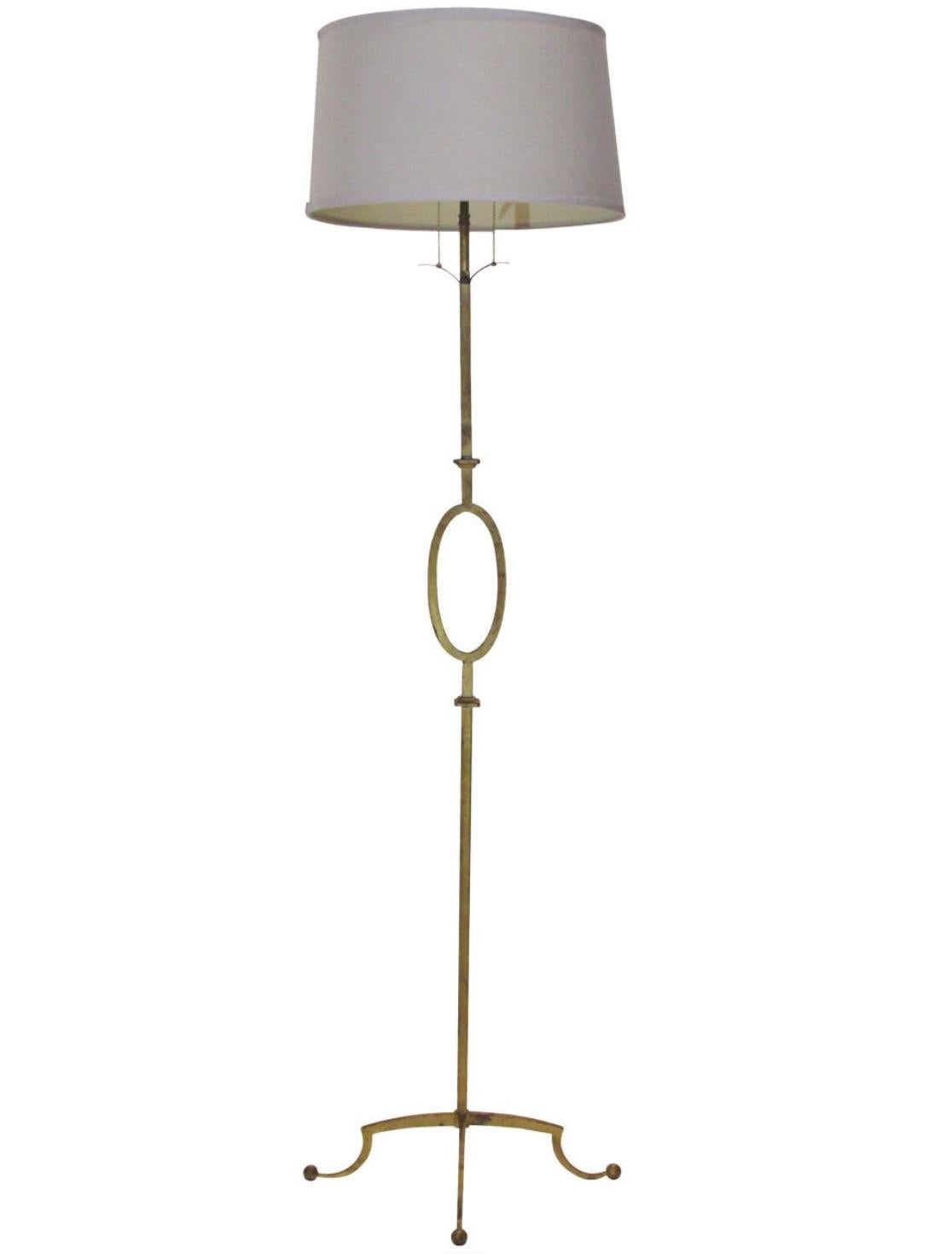 A vintage superb Chic Poillerat by Mattaliano pair of hand-wrought iron floor lamps with an oval shape feature detail, in prized gilt finish, with an extendable height double two lamp holder and iron finial-round beige shades.

An elegant 67 1/2