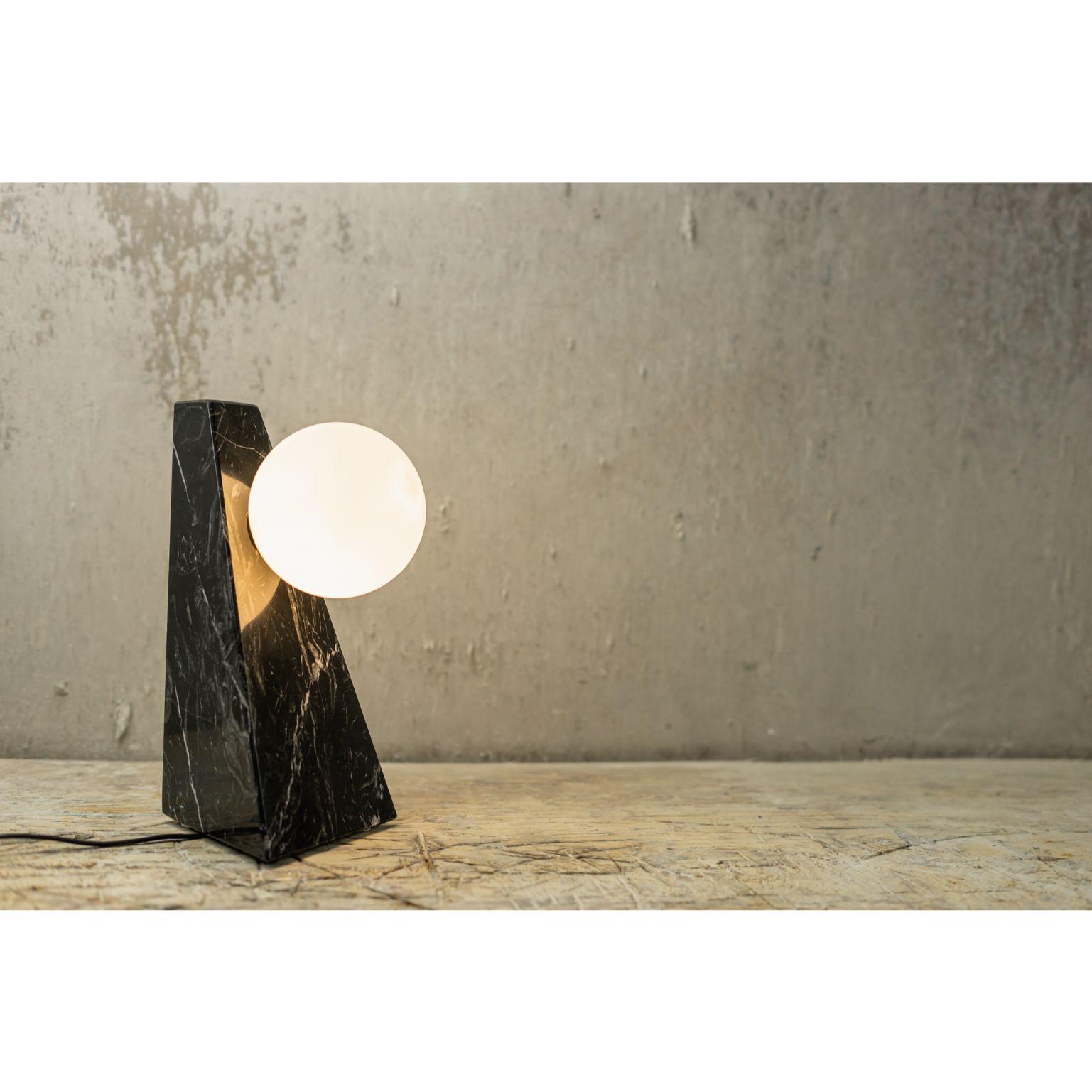 Point of contact marble lamp by Essenzia
Materials: Nero Marquina
Dimensions: 30 x 18 x 20 cm

Also Available: Carrara, India Green

Table lamp that explores the concept of gravity suspension and interaction between two different cosmic