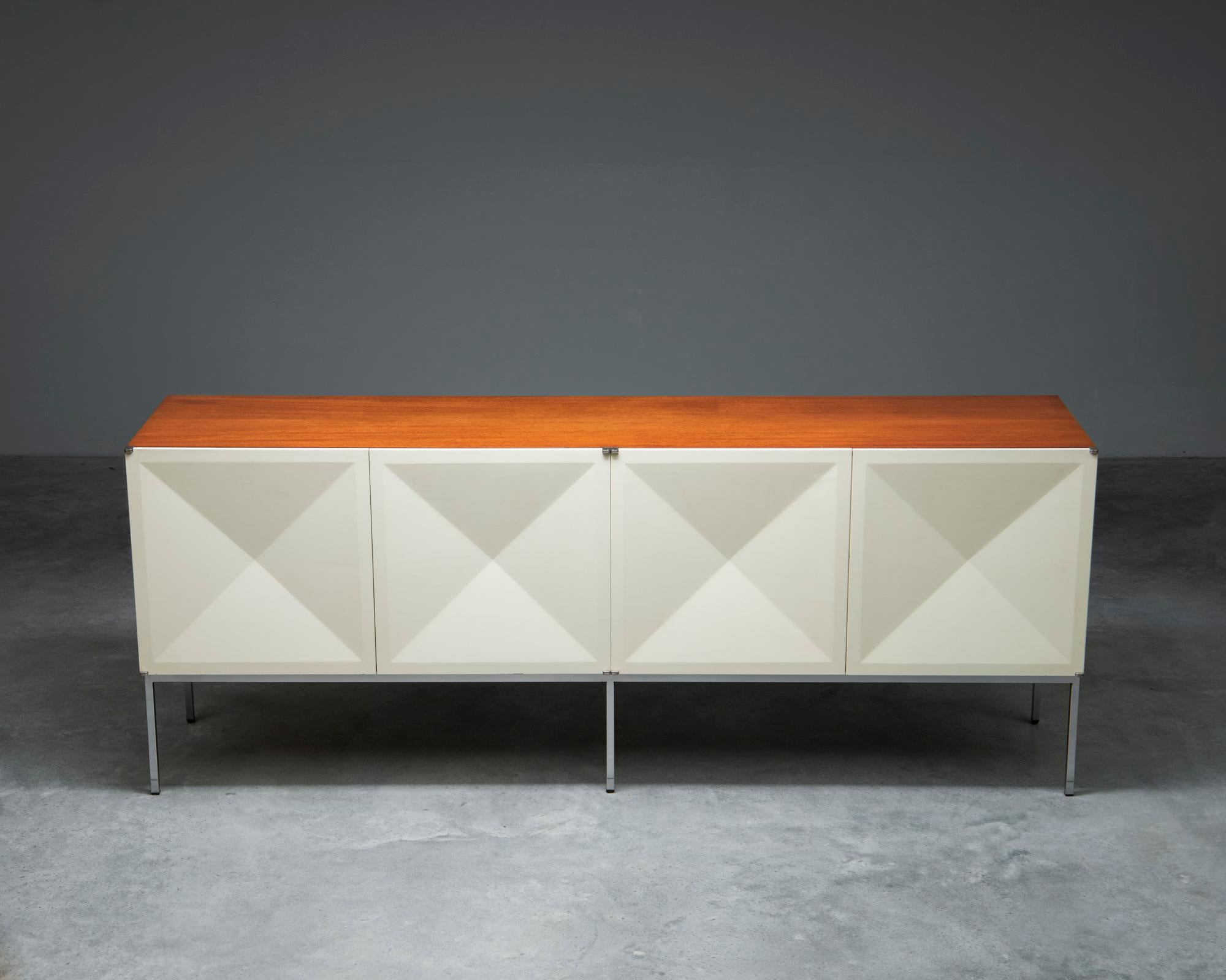 A rare Model 1307 or 'Pointe De Diamant' sideboard, designed in 1964 by French duo Antoine Phillipon & Jacqueline Lecoq. Manufactured by Behr, Germany. The sideboard consists of a mahogany veneered corpus with 4 white doors, on a brushed steel