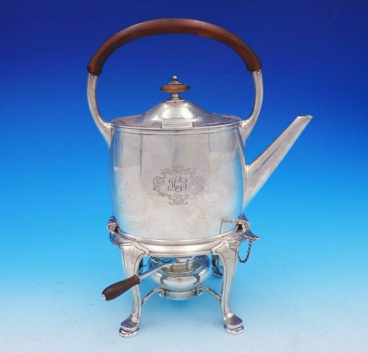 Pointed End by Arthur Stone

Marvelous pointed end by Arthur Stone Arts & Crafts sterling silver 6-piece tea set circa 1901-1937 in MA. It features carved wood handles and wood accents on the finials. This set includes:

1 - Kettle on stand: