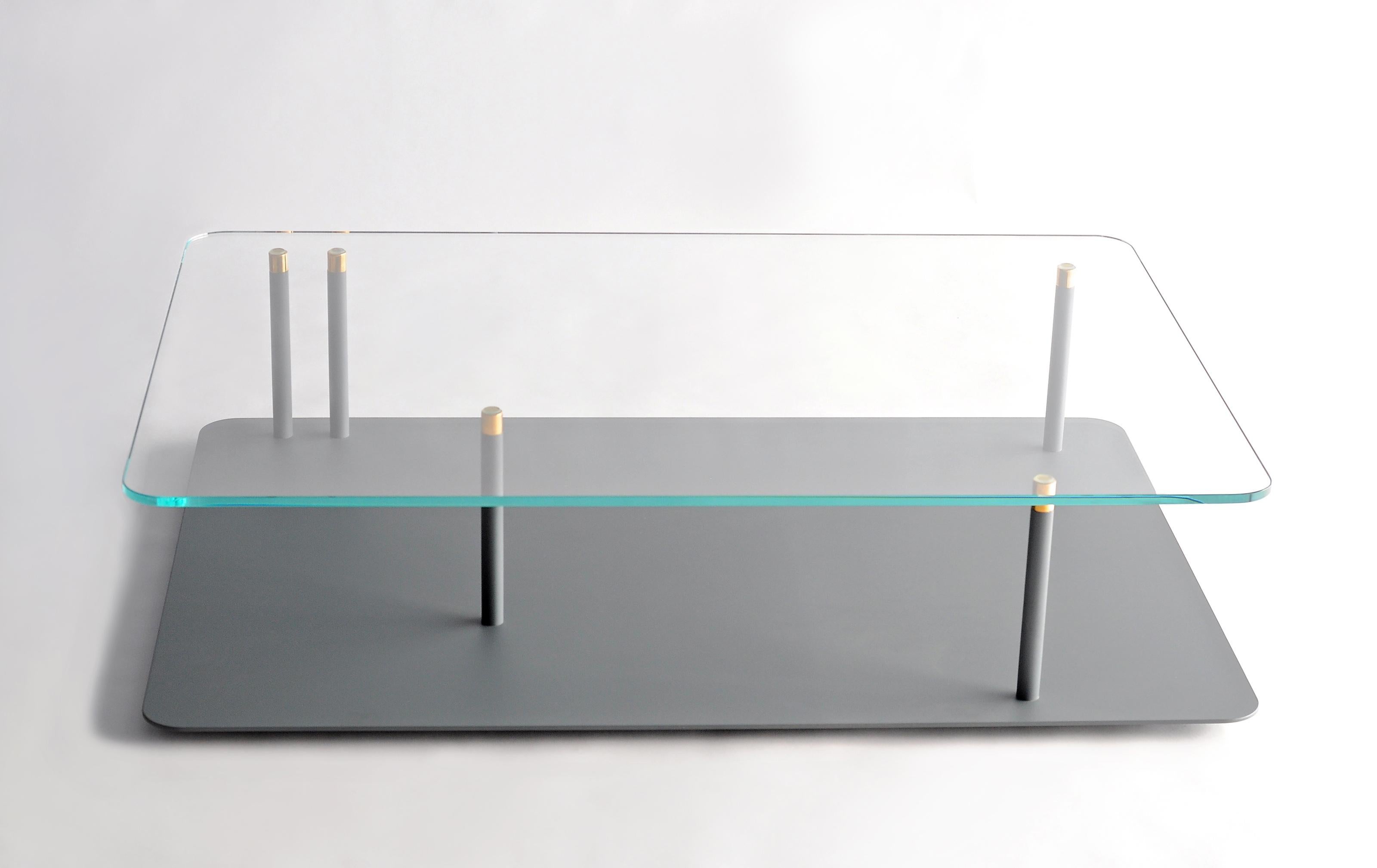 Points of Interest Rectangular Coffee Table by Phase Design
Dimensions: D 96.5 x W 88.9 x H 29.2 cm. 
Materials: Powder-coated steel, glass and brass.

Powder-coated steel base with solid brass tips and available with starphire glass top. Powder