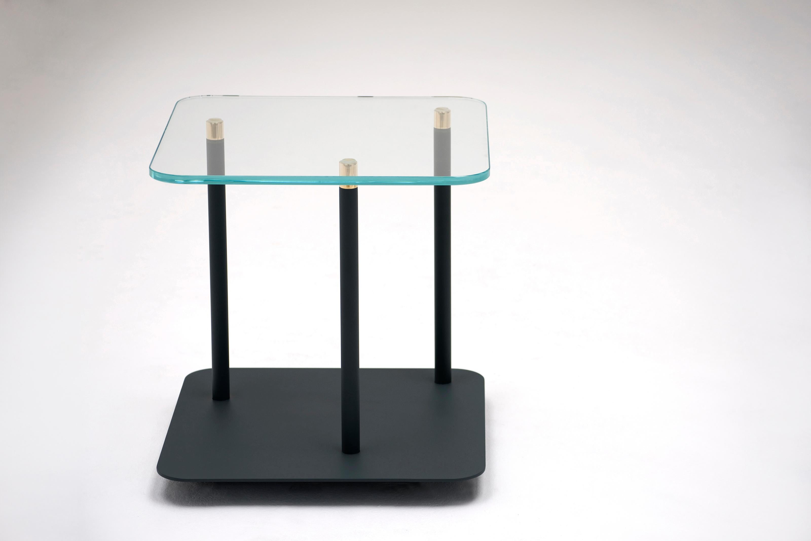 Points of Interest Side Table by Phase Design
Dimensions: D 45.7 x W 45.7 x H 44.5 cm. 
Materials: Powder-coated steel, glass and brass.

Powder coated steel base with solid brass tips and available with starphire glass top. Powder coat finishes