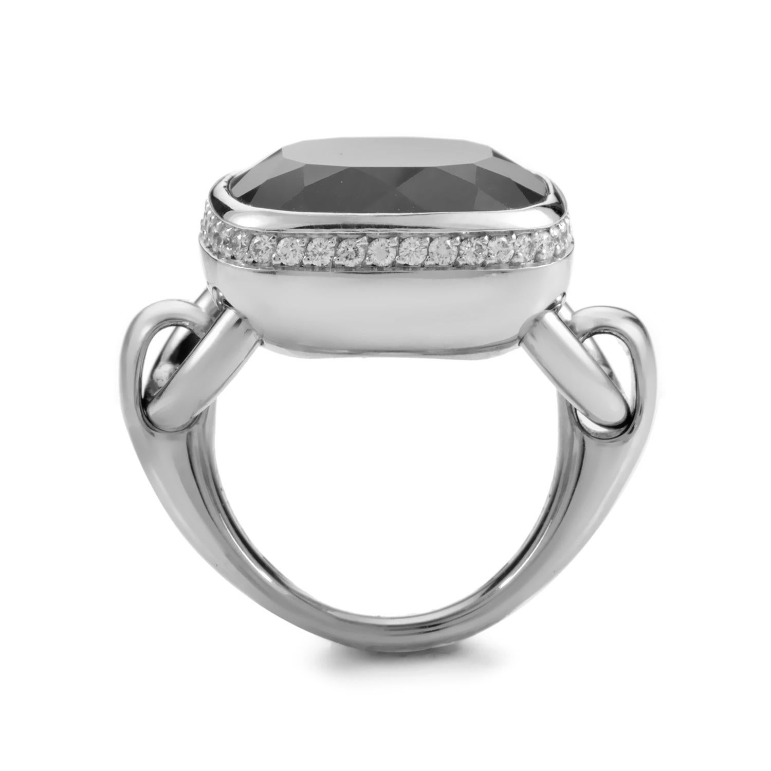 This eclectic Poiray ring is enigmatic and distinctive. The ring is made of 18K white gold that is specially designed with hinges for a smooth, movable, cushion shaped bezel setting. A faceted gray agate totaling a generous ~10ct smoothly displayed