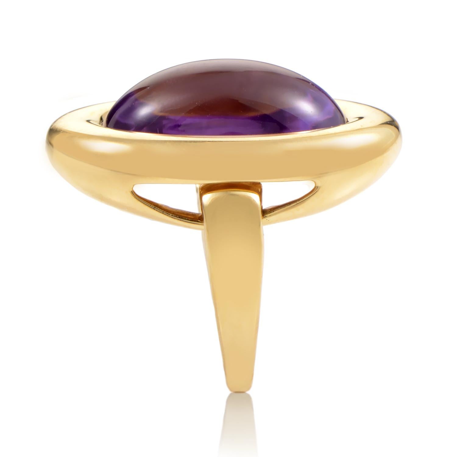 This exquisite Poiray ring is absolutely unforgettable. The ring is made of 18K yellow gold that is specially designed with hinges for a smooth, movable, quintessentially Poiray cabochon stone and setting. A stunning amethyst that totals a lavish