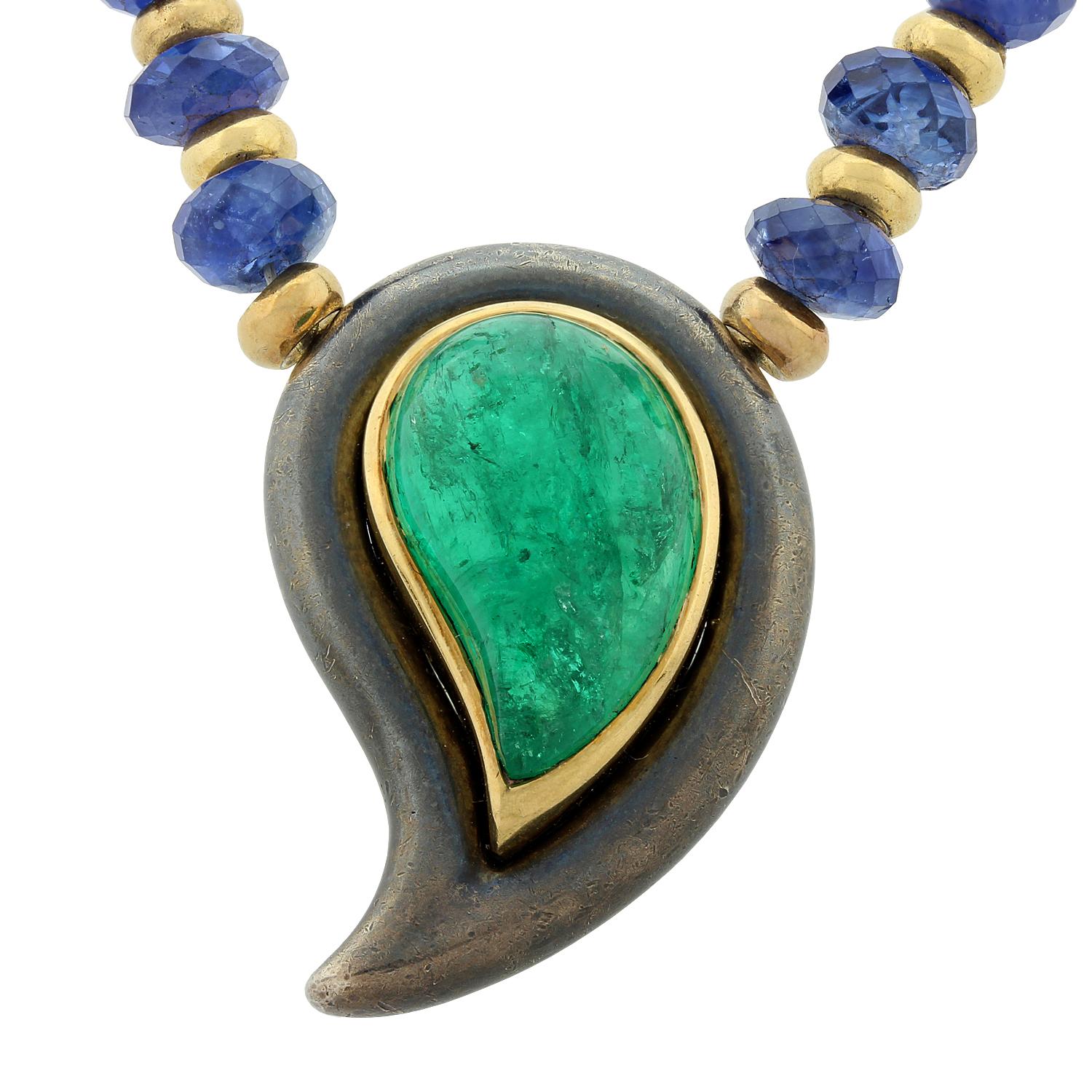 A wonderfully unique necklace by the French jewelry makers Poiray. It features a superb gem cabochon emerald with fine vivid green color. 
Gem quality faceted sapphire beads run along the entire necklace strand with gold accents. Made in 18K yellow
