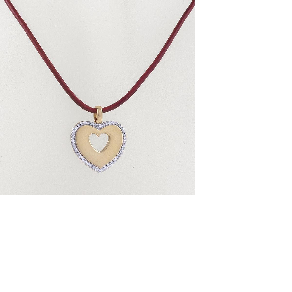 A French modern 18 karat yellow gold and red leather cord pendant necklace with diamonds by Poiray. The heart pendant necklace has round diamonds with an approximate total weight of .25 carat.  Circa Early 21st-Century. with New 18kt white gold