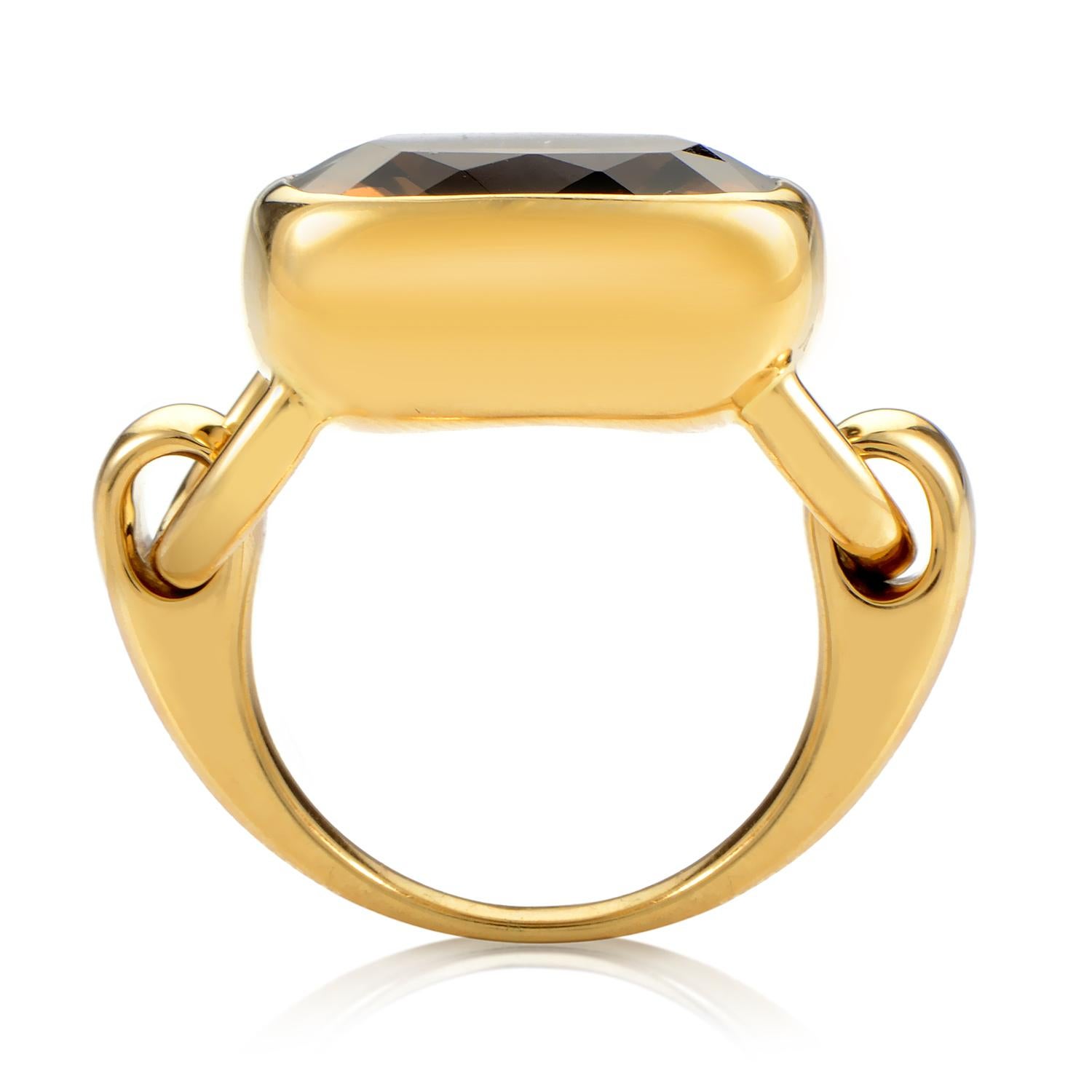 Power and glamour combine in this Poiray ring that embodies opulence. The ring is made of 18K yellow gold that is specially designed with hinges for a smooth, movable cushion shaped bezel setting. A faceted smoky quartz totaling ~8.65ct captures