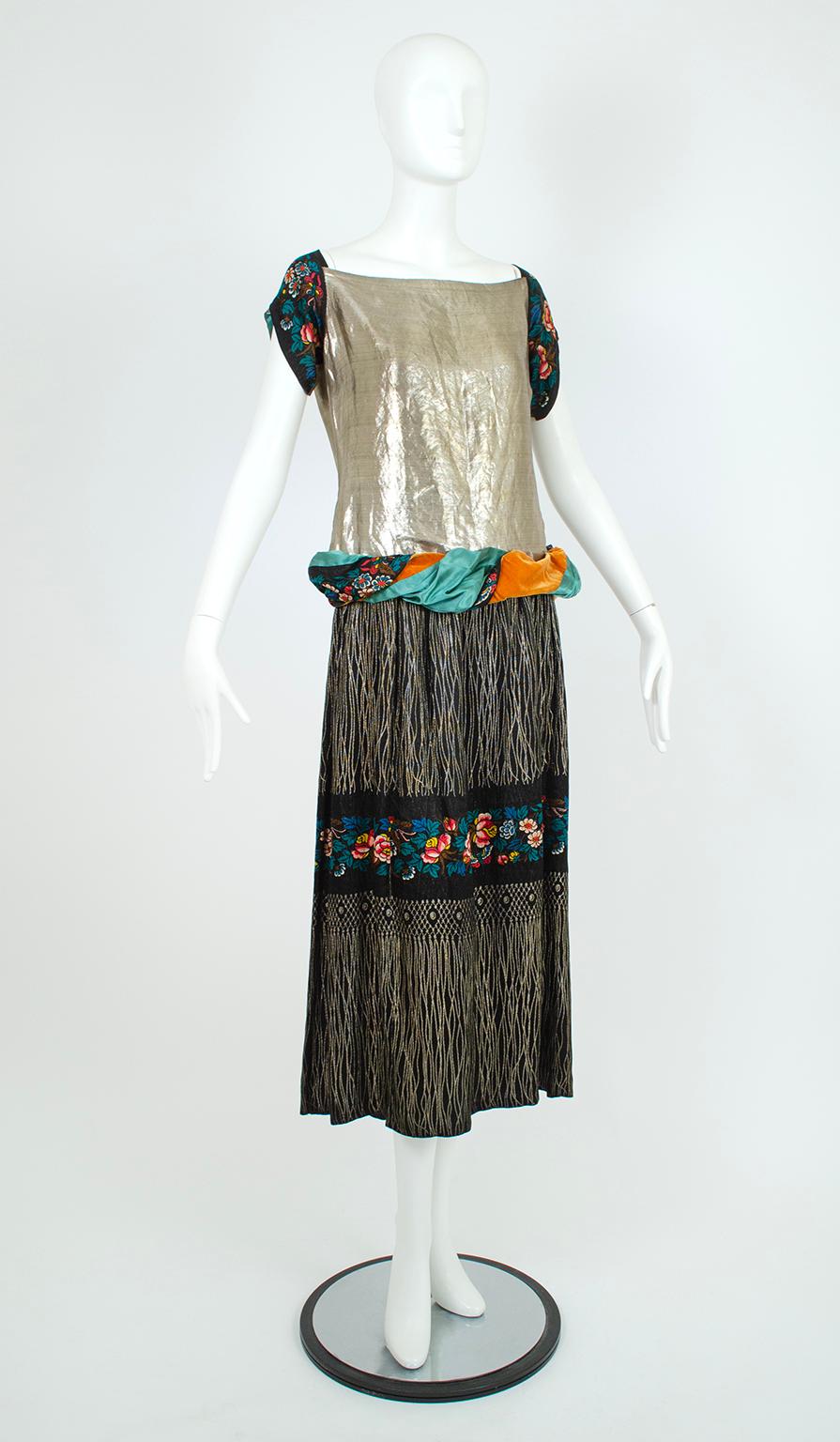 Clearly inspired by Poiret’s Irudrée gown of 1923 (pictured), this dress features the same dropped rouleau waist and emphasis on metallic lamé, but also incorporates aspects of his other work. The exotic mustards, blues and pinks of his 1002nd Night