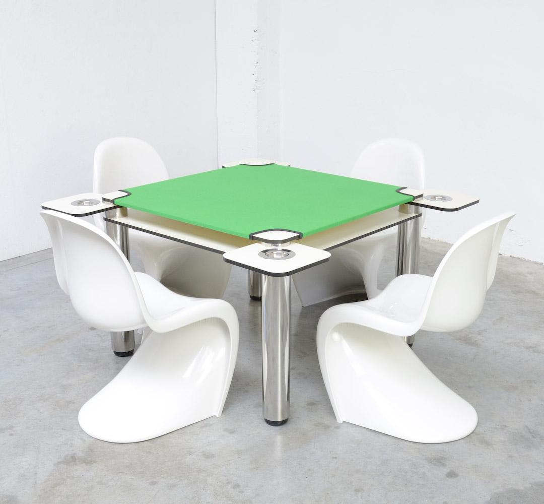 This great card table – Poker – was designed by Joe Colombo in 1968 for Zanotta S.p.A., Italy.
The top is made of layered white plastic laminate and the tubular legs are made of stainless steel with black plastic levels.
The table is complete with