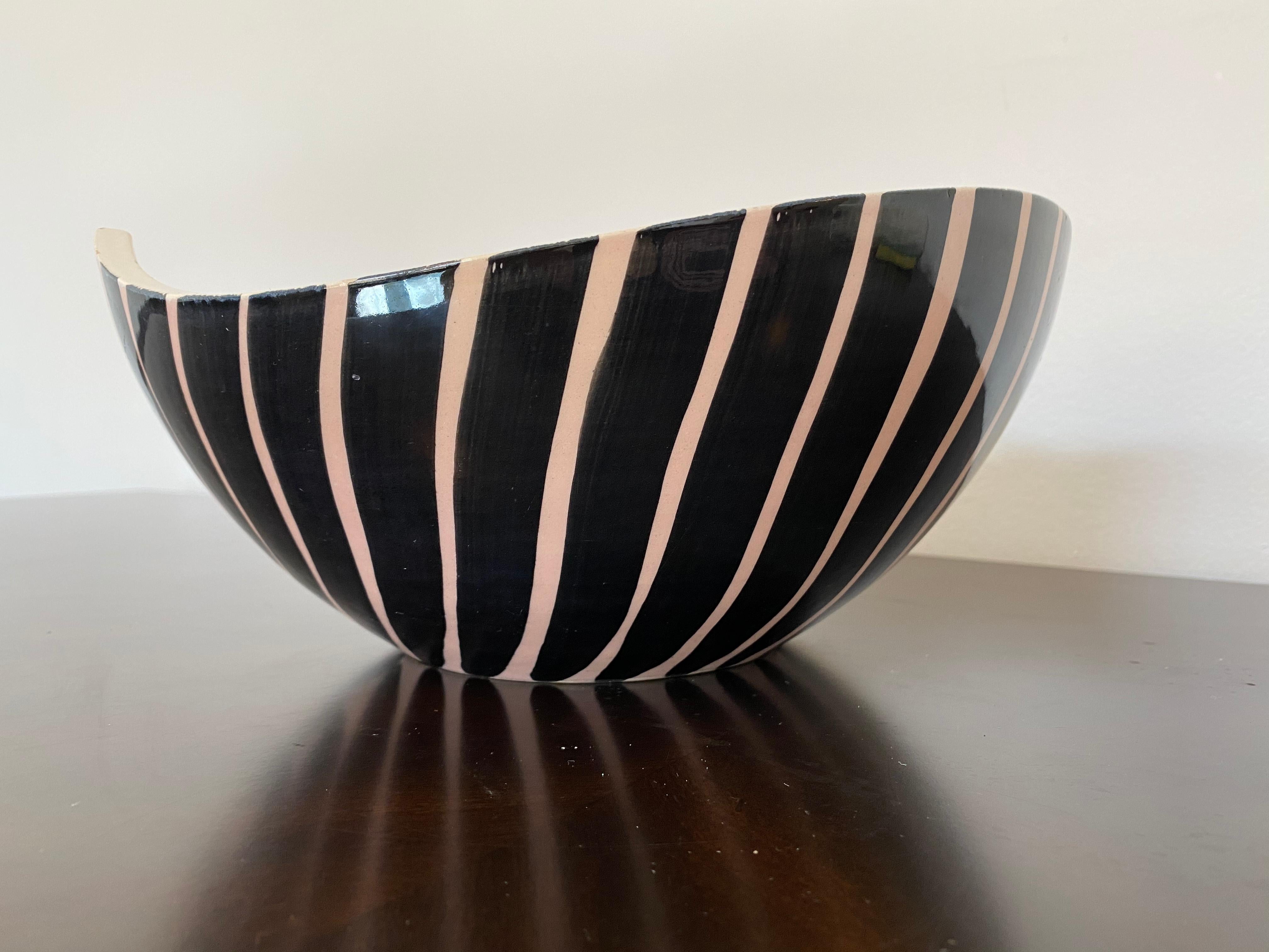 An original 1960s pale pink and black striped glossy glazed bowl by famed French ceramicist, Pol Chambost. Signed. The inner bowl is a mottled pale pink. The top shape is either a heart or tear drop.