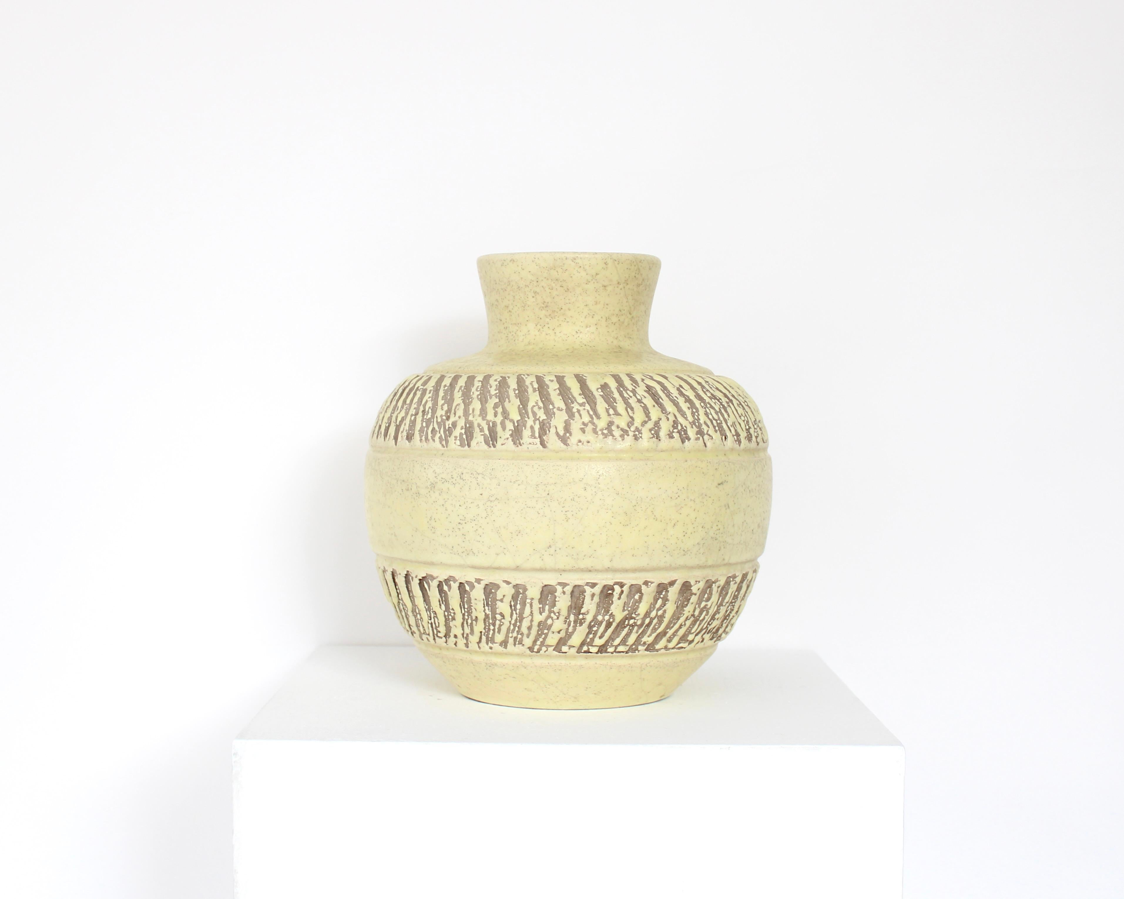 Ceramic vase by French ceramic artist Pol Chambost featuring a pale lemon yellow glaze with deep brown incised decoration. Perfect condition. Unsigned.