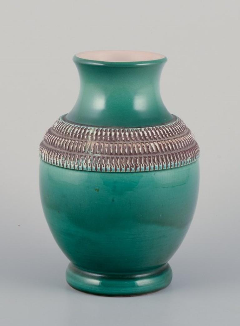 Pol Chambost (1906-1983), French ceramist.
Hand-decorated ceramic vase with green-toned glaze.
Approximately from the 1940s.
In excellent condition with natural cracks.
Marked.
Dimensions: H 22.5 cm x D 14.0 cm.