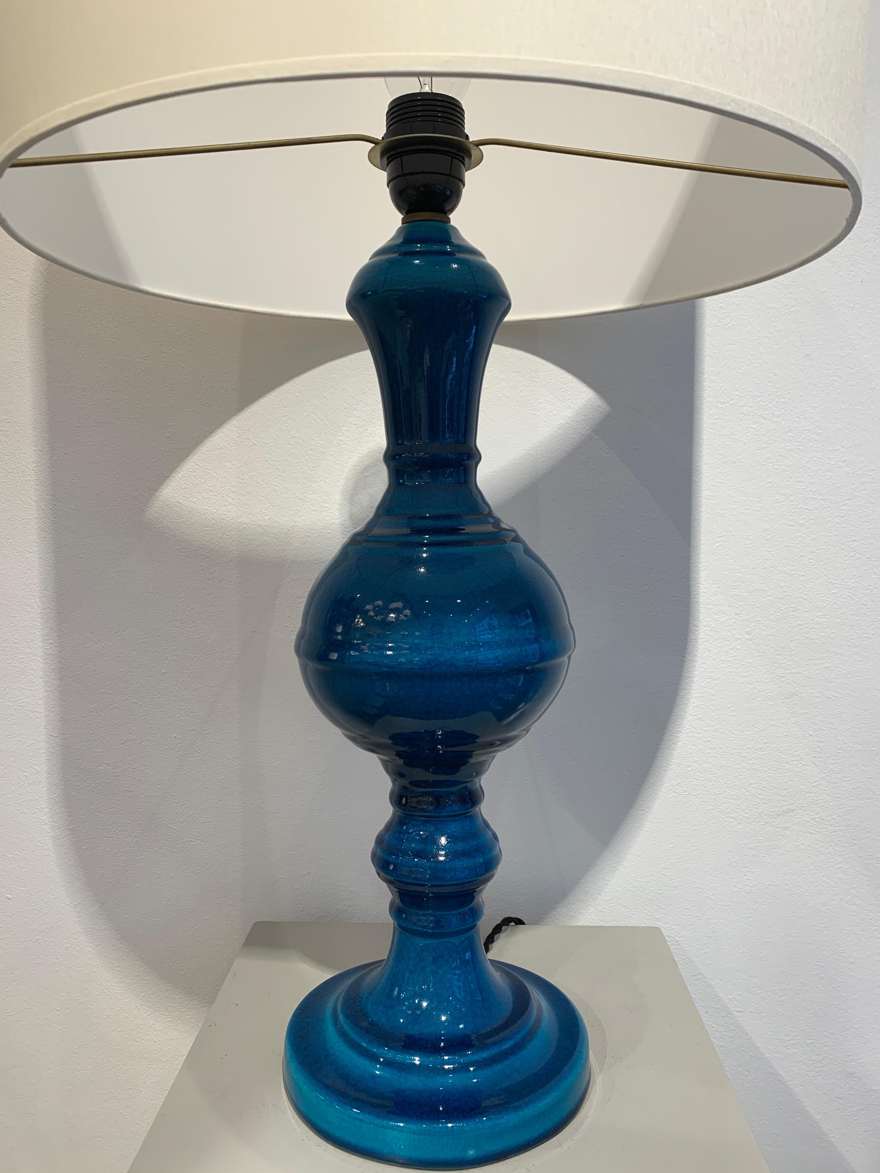 Pol Chambost is a famous French ceramist active in the 1950s-1970s. This particular lamp is a faience in beautiful turquoise color. The cracked effect is achieved through the baking and cooling process.