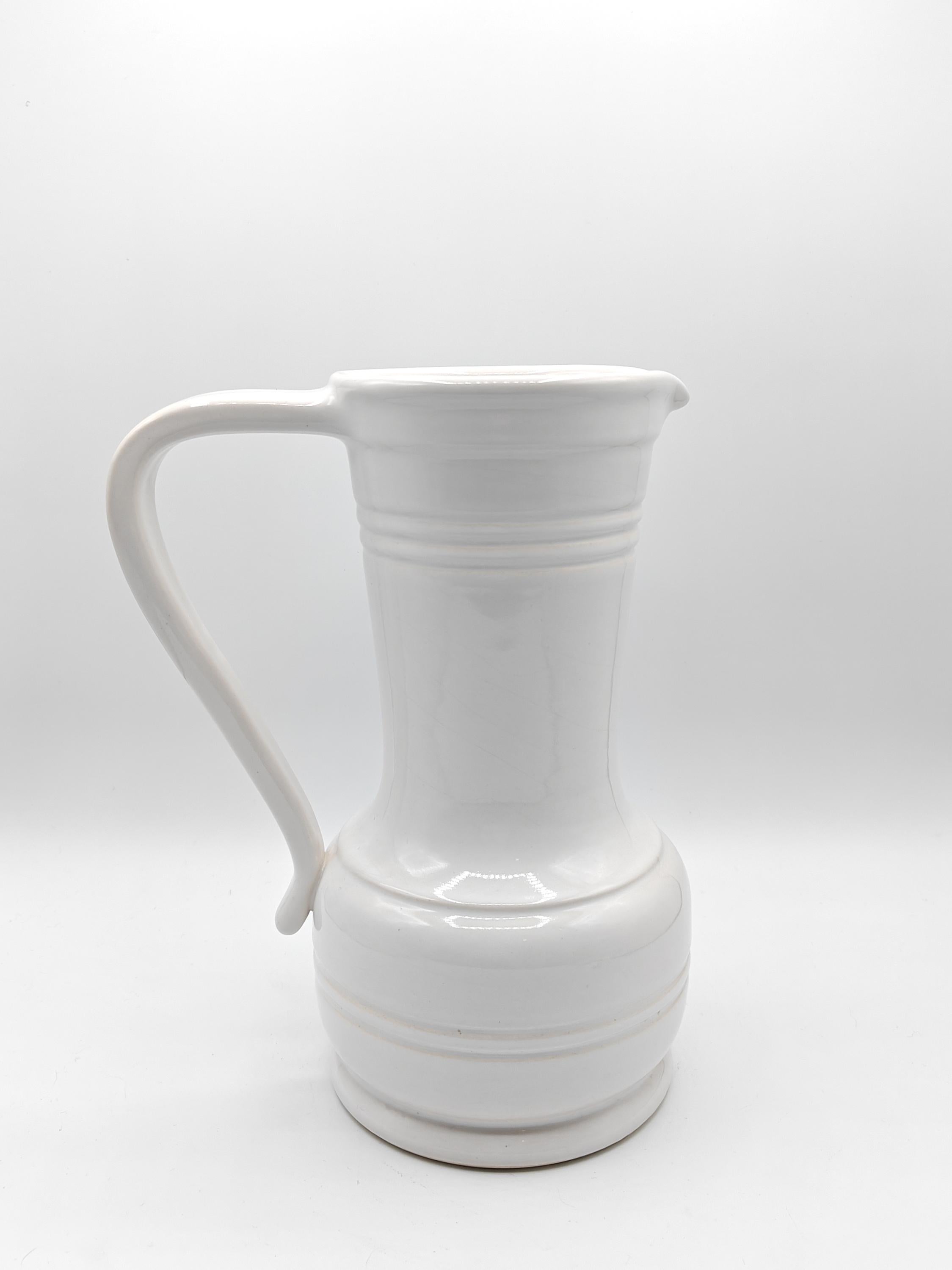 Very beautiful and rare pitcher by Pol Chambost from the early 1960s from a series where the pieces took their names from French regions and communes. This pitcher with pure white enamel and modern shapes, is signed 