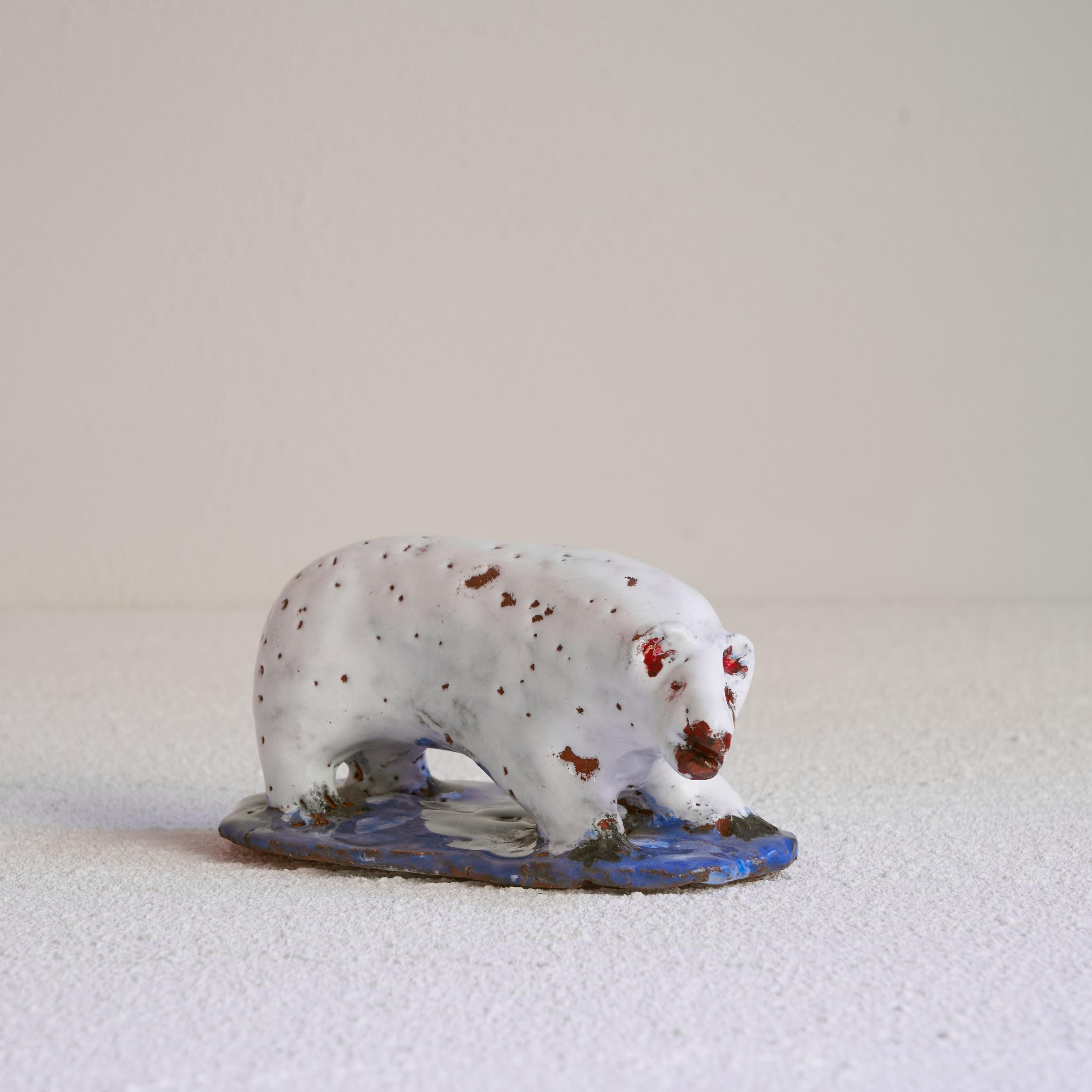 Polar bear sculpture in glazed clay, early 20th century.

Very tactile and honest sculpture of a polar bear in rough glazed clay. Very expressive and freely made sculpture with a beautiful polar white glaze and colorful details in red and blue. In