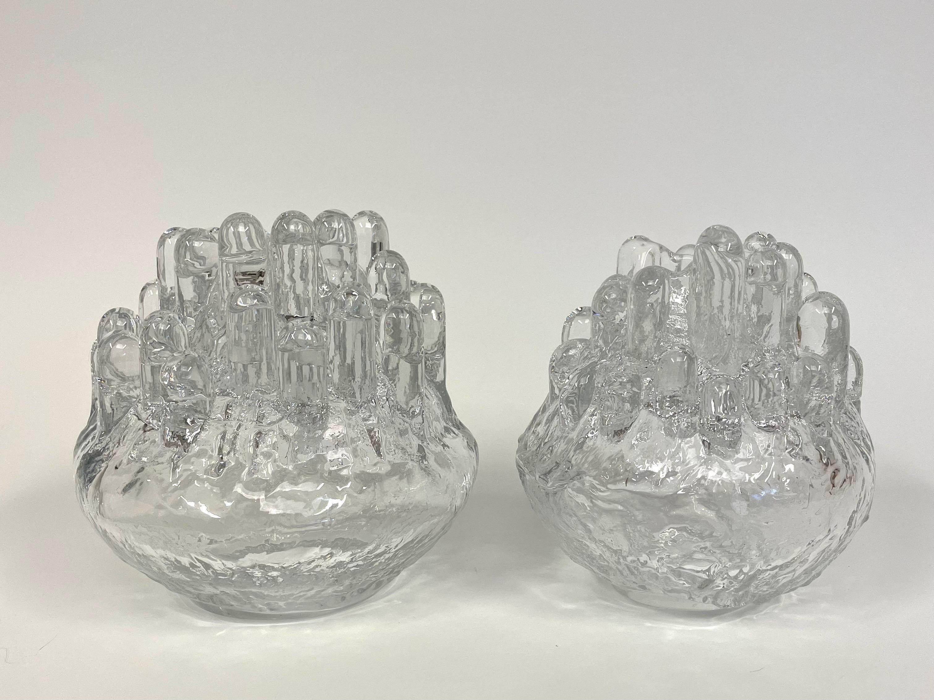 This is a pair of Polar crystal lantern in two different sizes by Swedish glass artist Göran Wärff for Kosta Glasbruk. 

It comes in bright crystal with a form that brings to mind a stalactite-like ice sculpture. 
The glass mass is transparent and