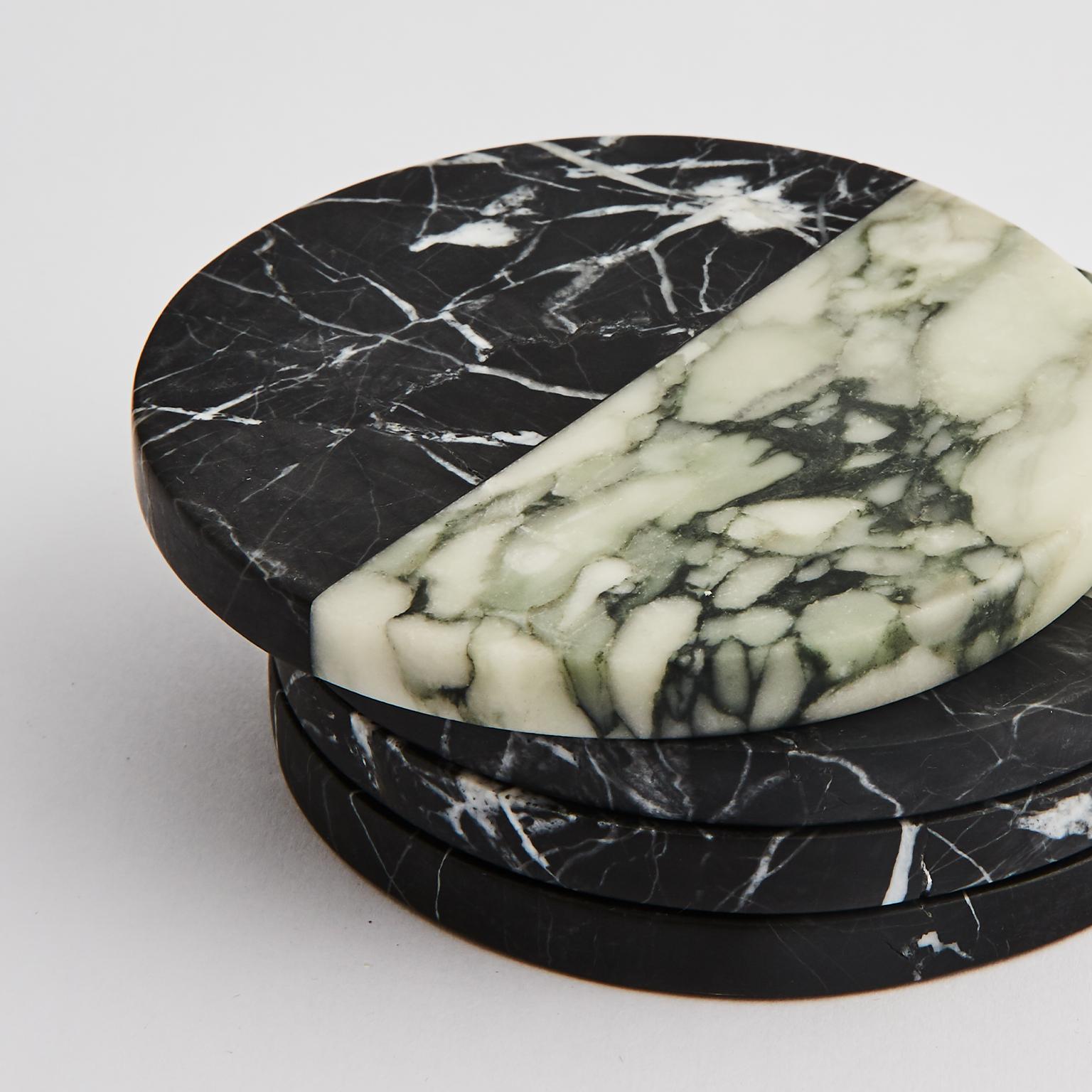 These polar coasters juxtapose the monochromatic beauty of Fiore and Nero marbles in an elegant set of four, each piece honed by hand and finished with a black felt base.

Dimensions: D 100 x 10 H mm each piece
Materials: Nero marble, Fiore