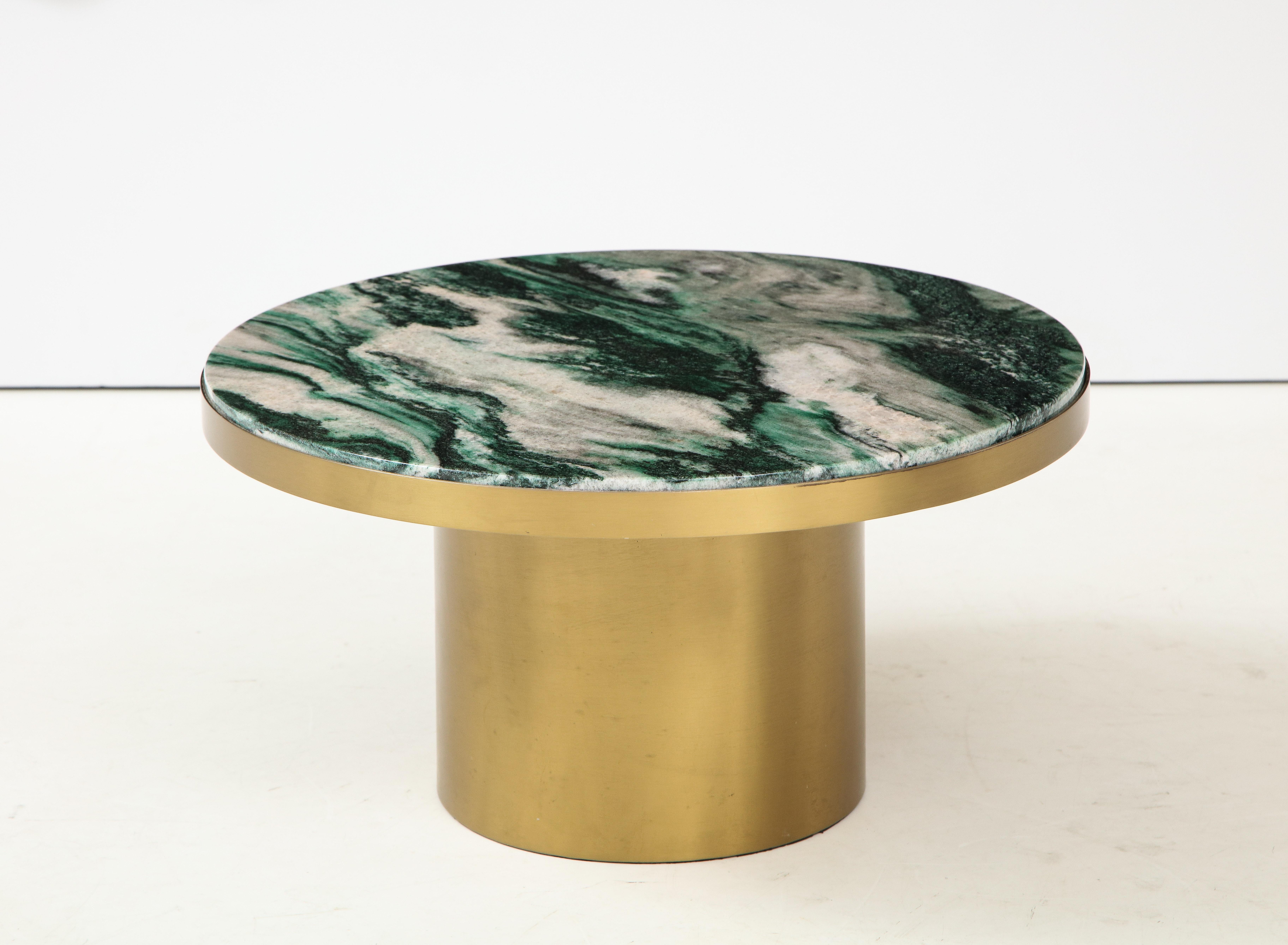 Low cocktail / coffee table with a beautiful piece of polished
Polar verde marble that sits on top of a brass base.