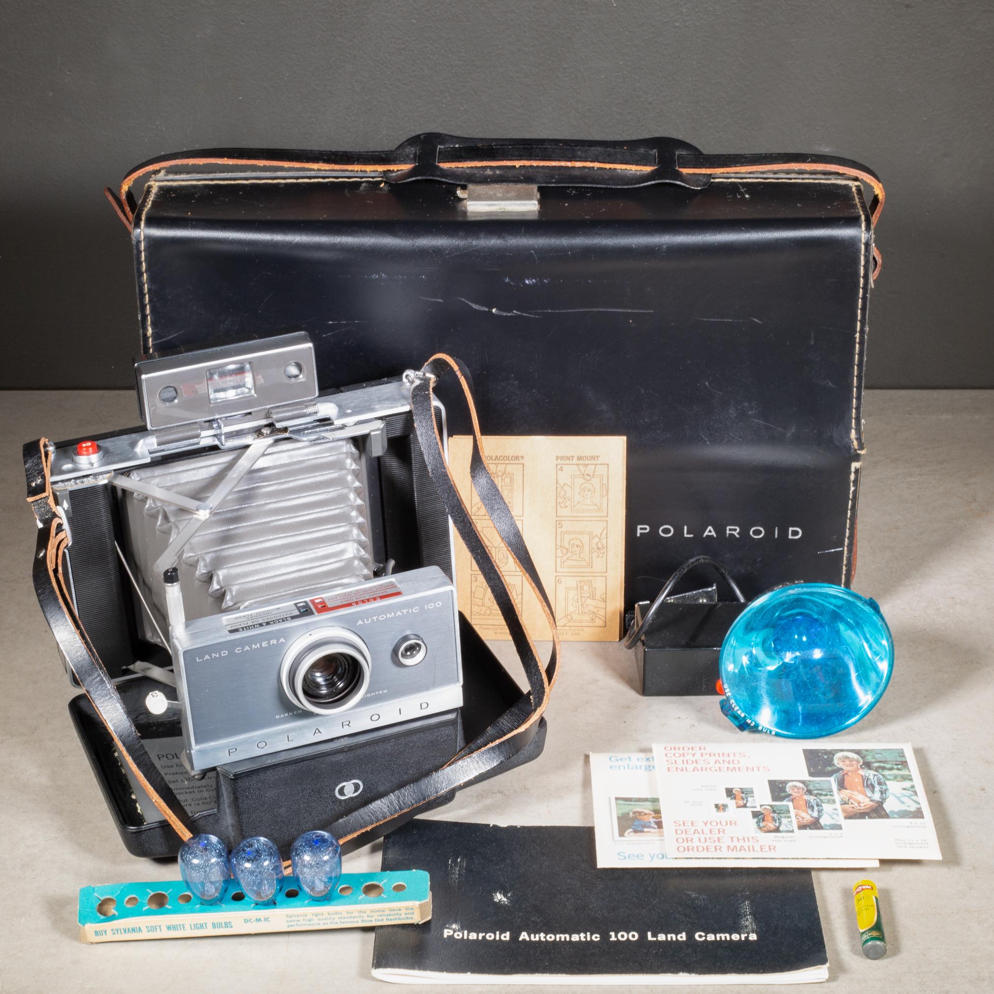ABOUT

A mid-century Polaroid Automatic 100 Land Camera with original clam shell case with leather handle. The camera folds easily out and in and the bellows appear to be intact. The camera includes all original leather carrying case, instruction