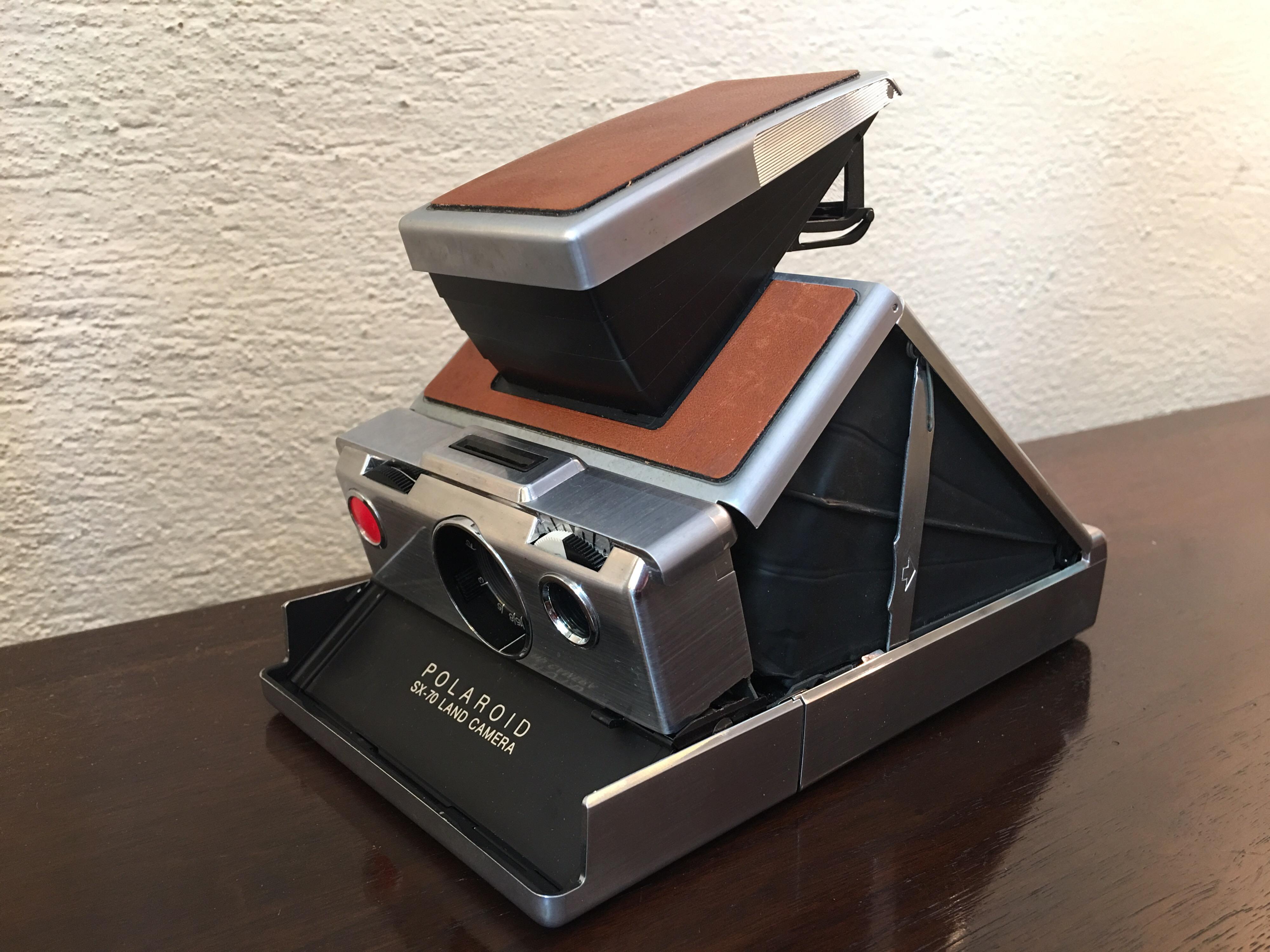 Classic land camera designed by Edwin H. Land in 1972. Folds flat and slides into leather case. Film is still available!
